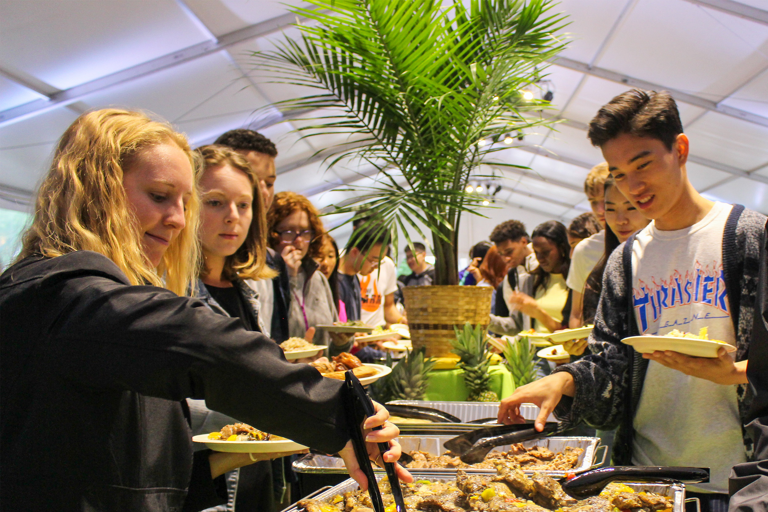 Taste of the Islands food bar with students lining yo