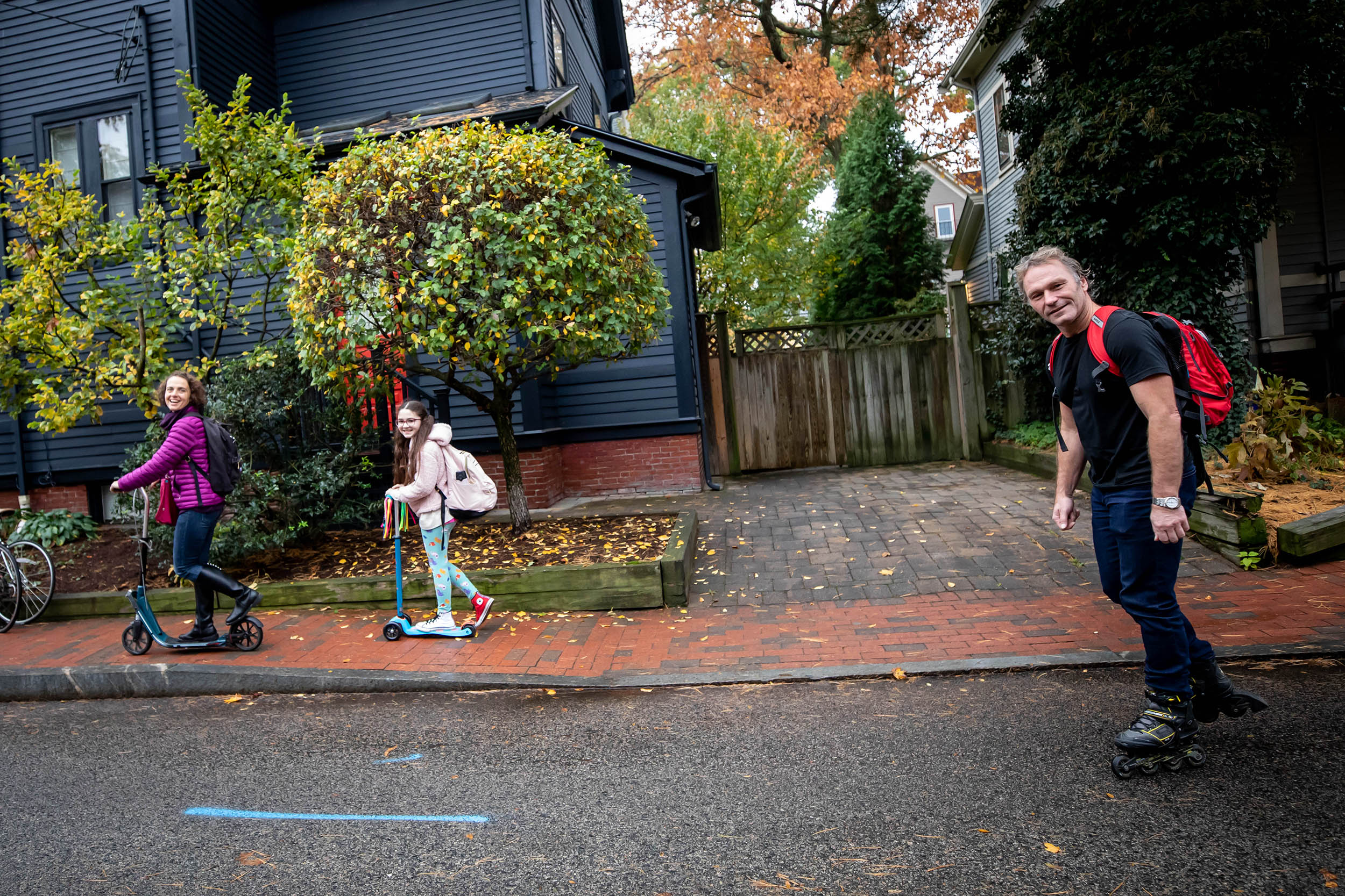 Family on scooters and skateboards.