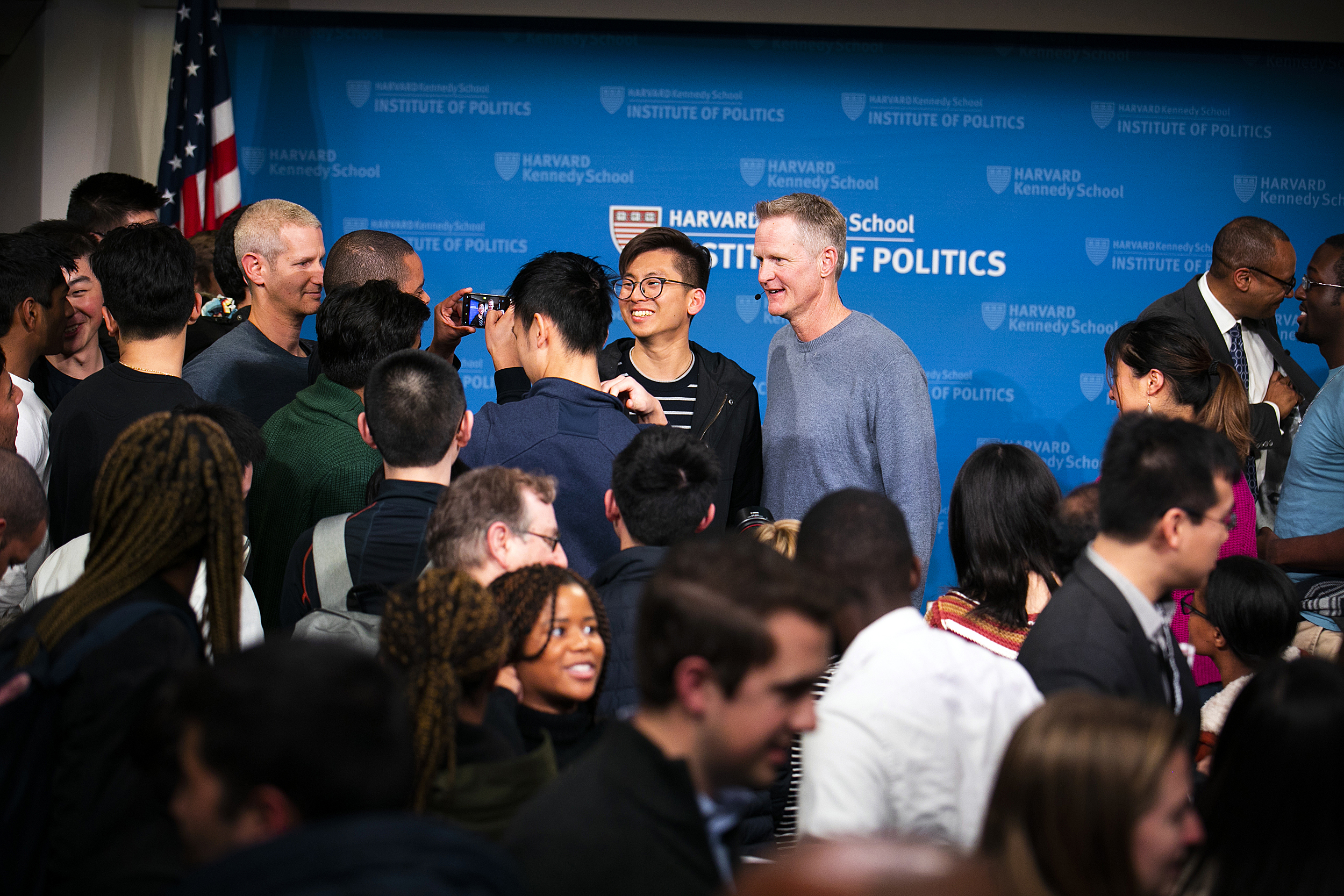 Steve Kerr surrounded by students.