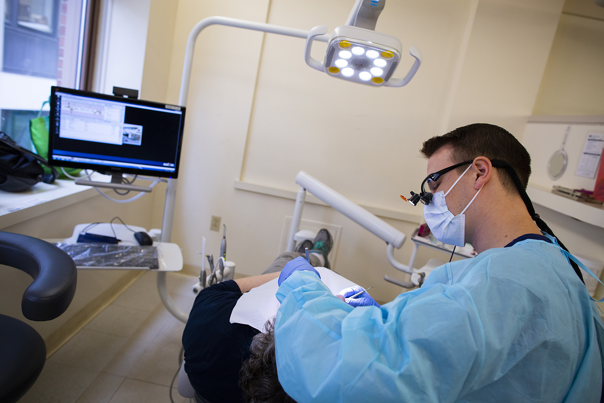 Dental School student working with a patient.