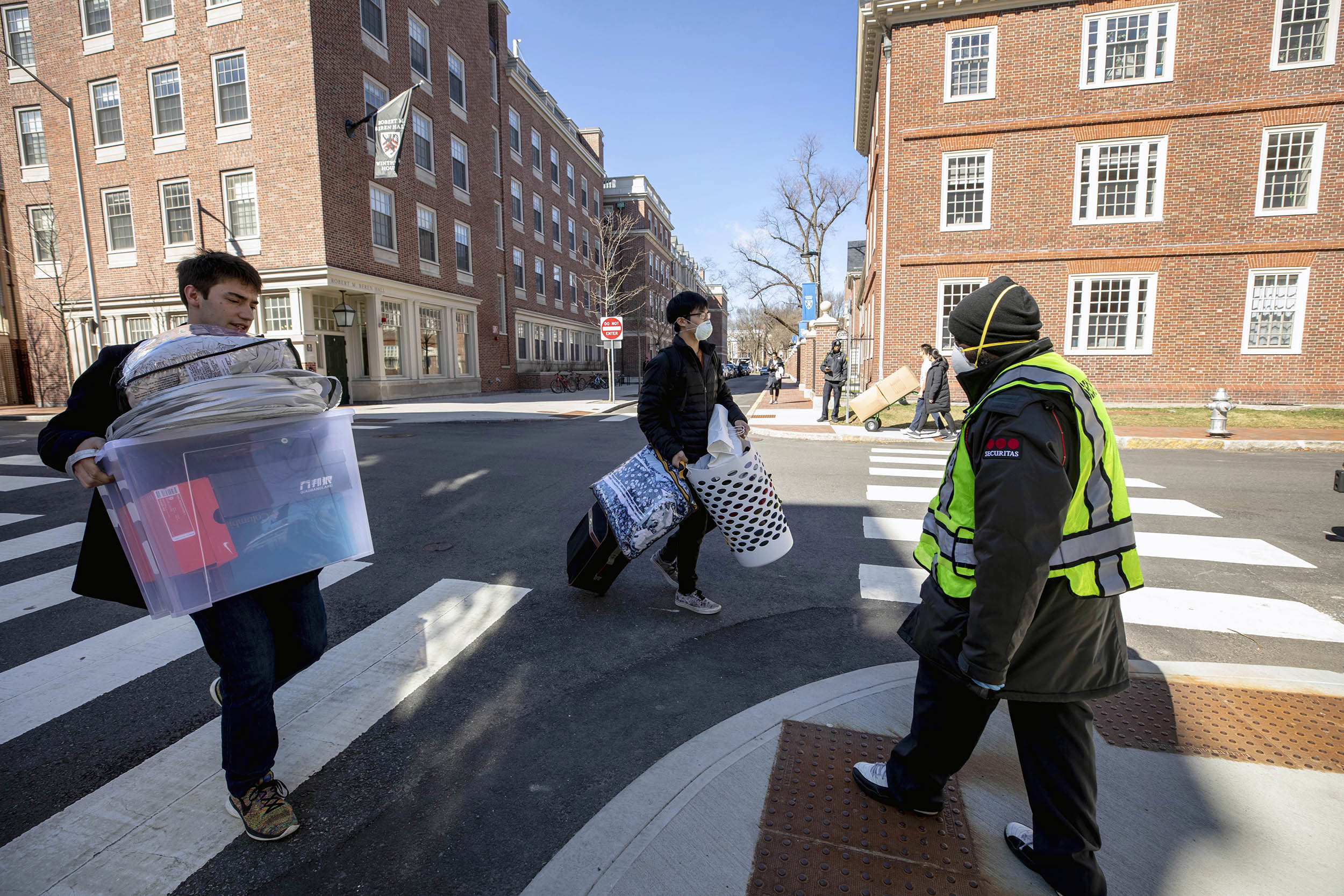 Security guard helping students cross the street.