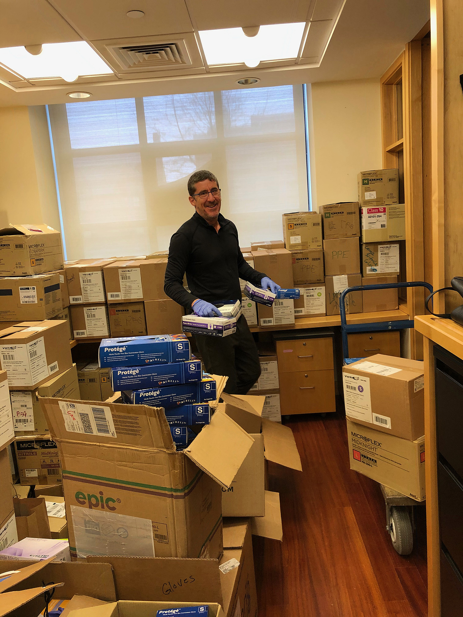 Man standing with boxes.