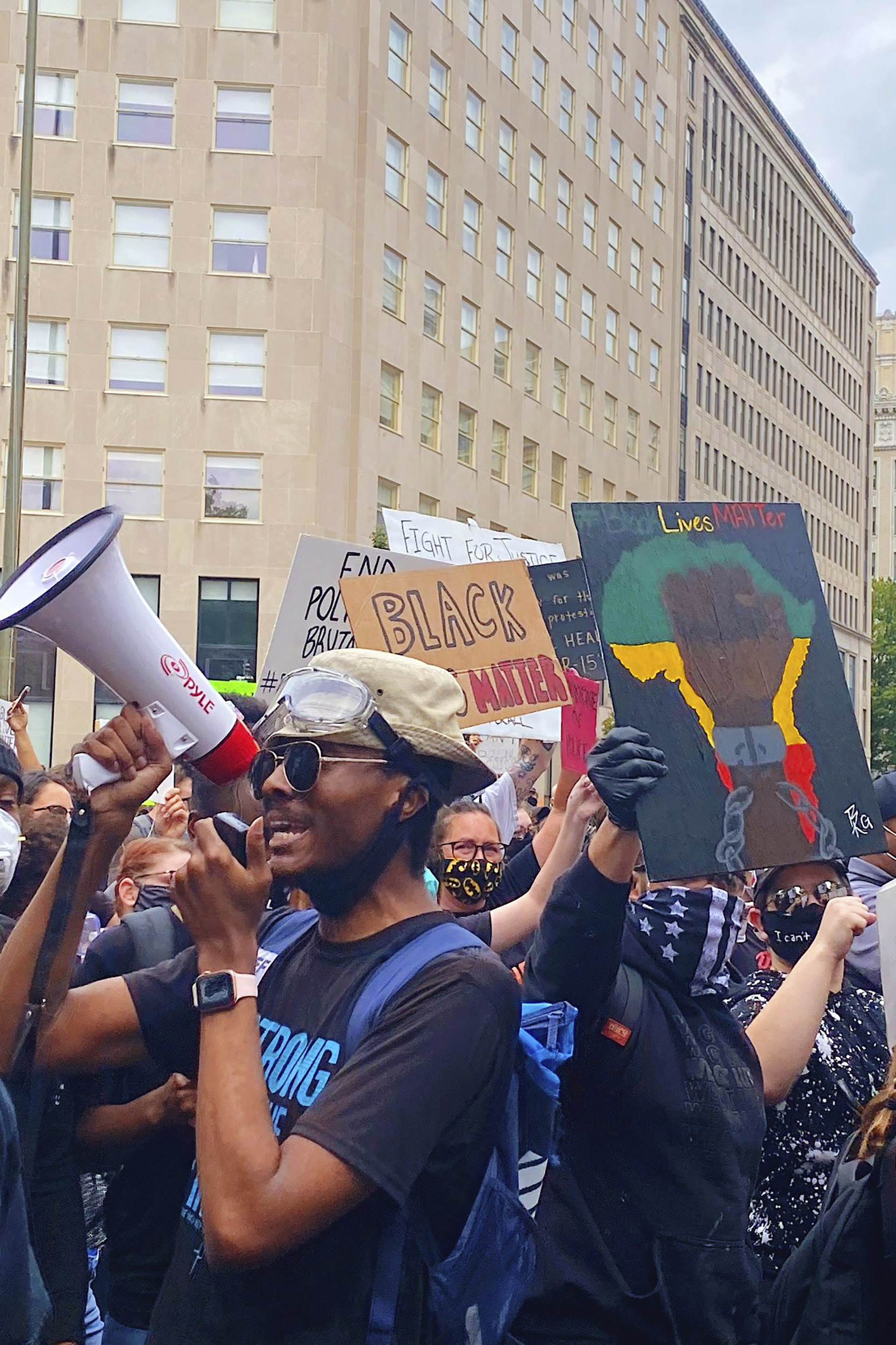 Glenn Foster holds bullhorn at protest.