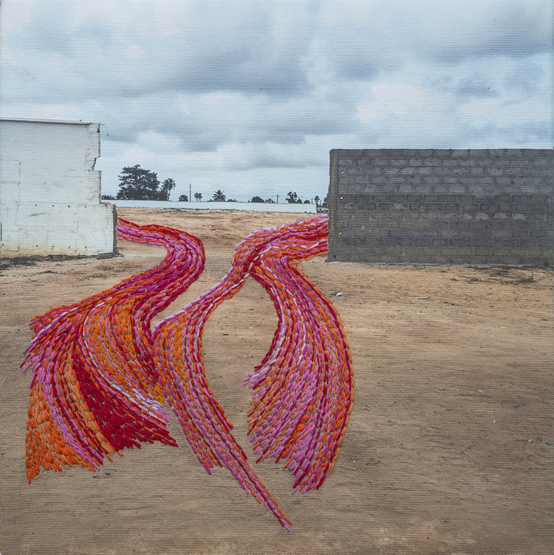 Bright embroidery overlays photo of concrete barriers.