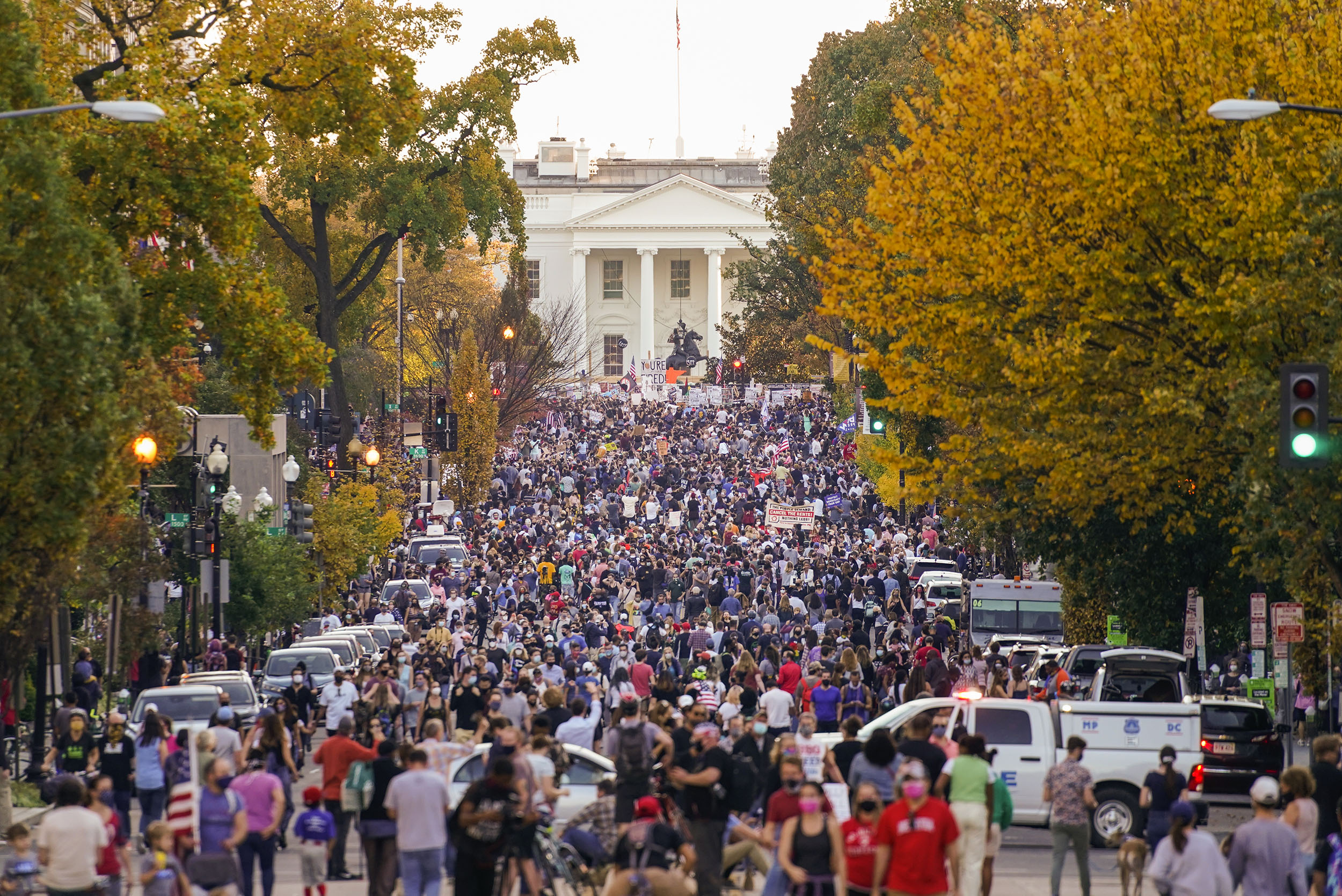 People gather along 16th street in front of the White House.