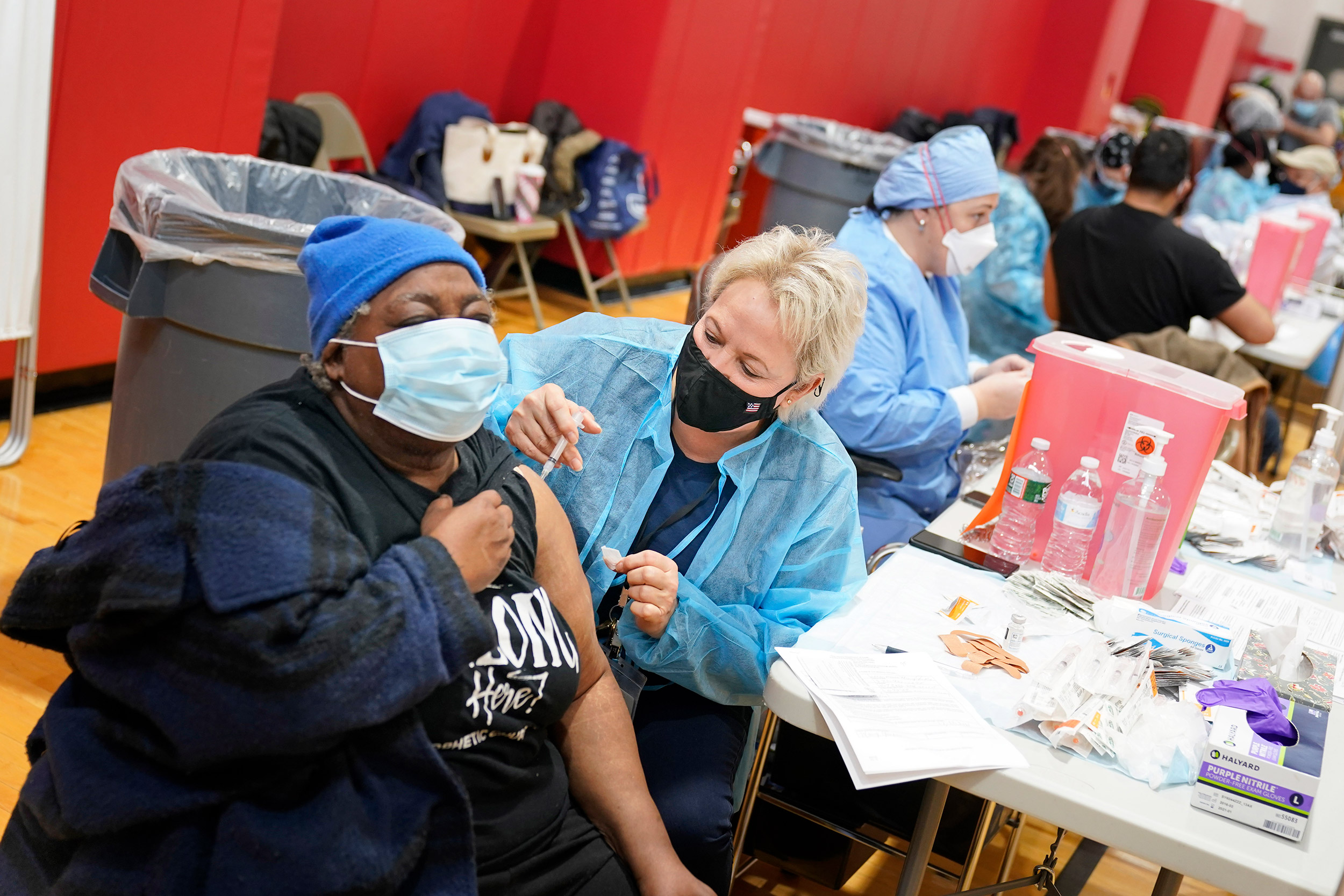 Woman getting vaccine at clinic.