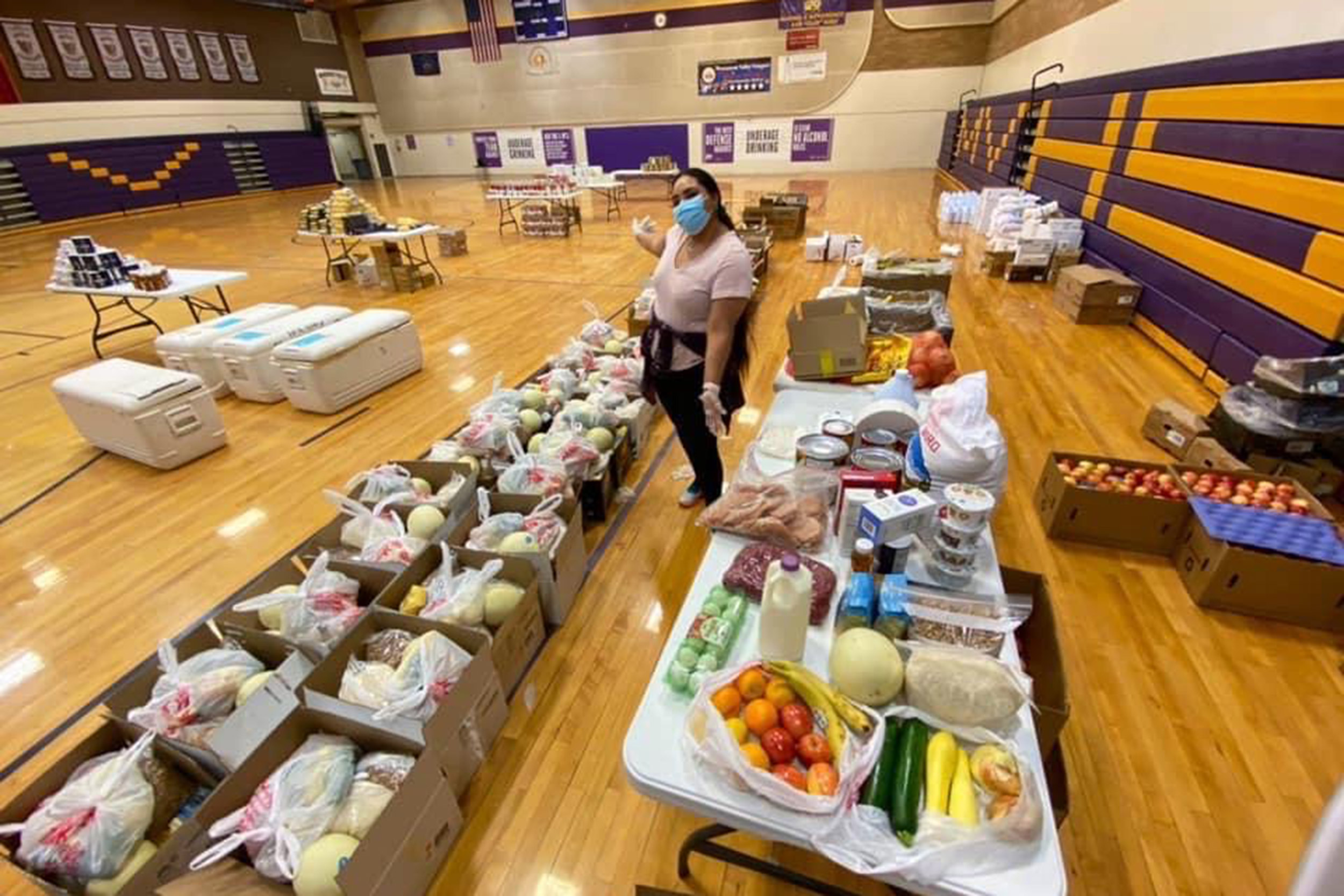 Shandiin Herrera assembles food boxes.