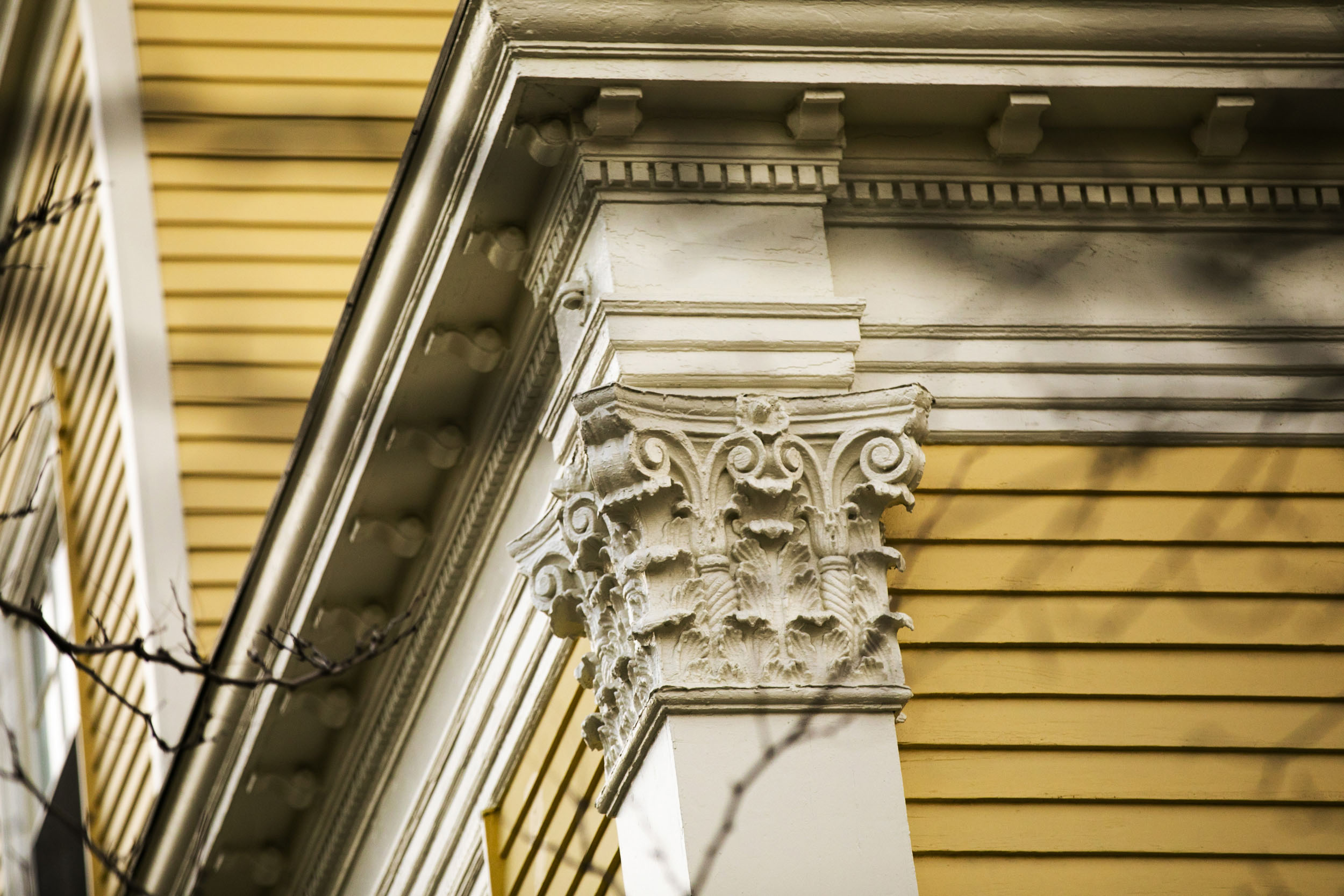 Wooden clapboards and decorative columns adorn one of the buildings.