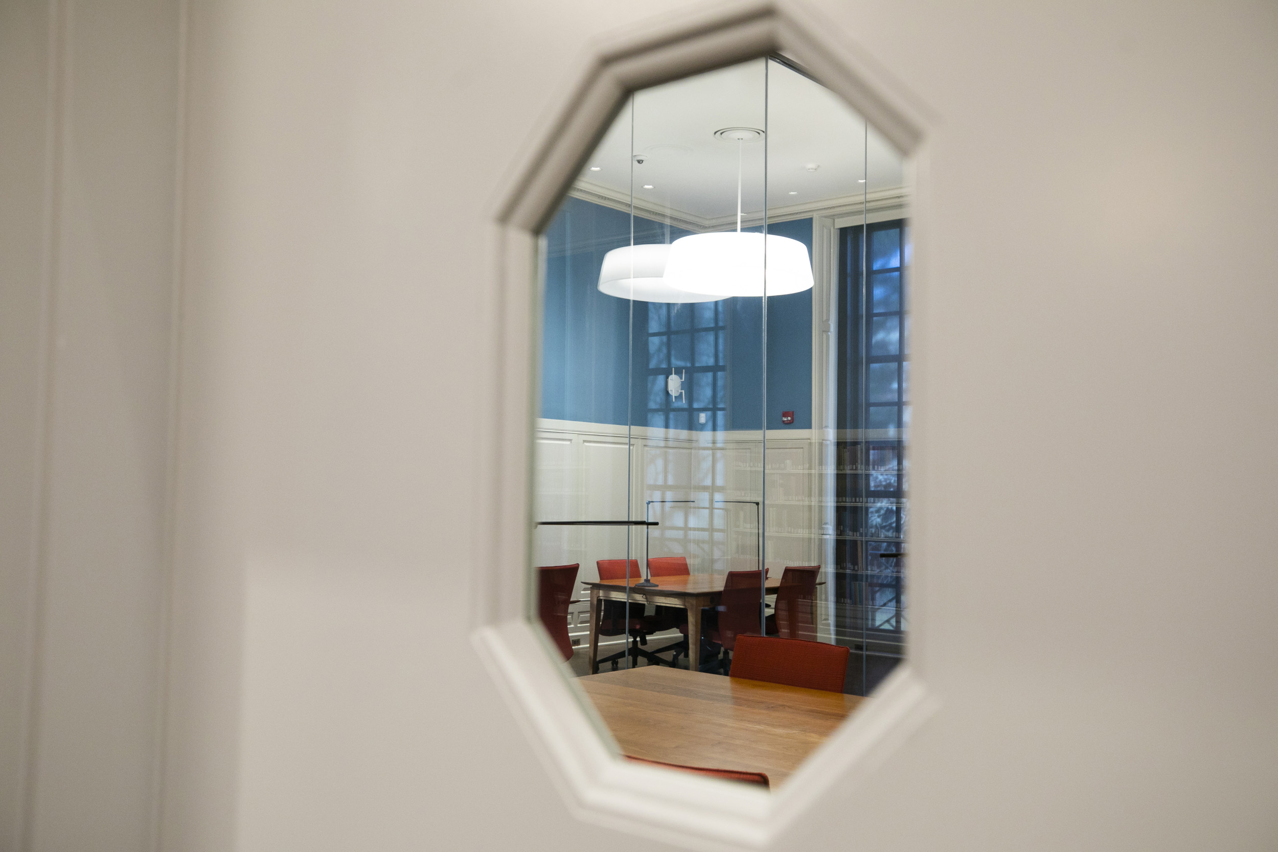 A window looks on to a smaller reading room.