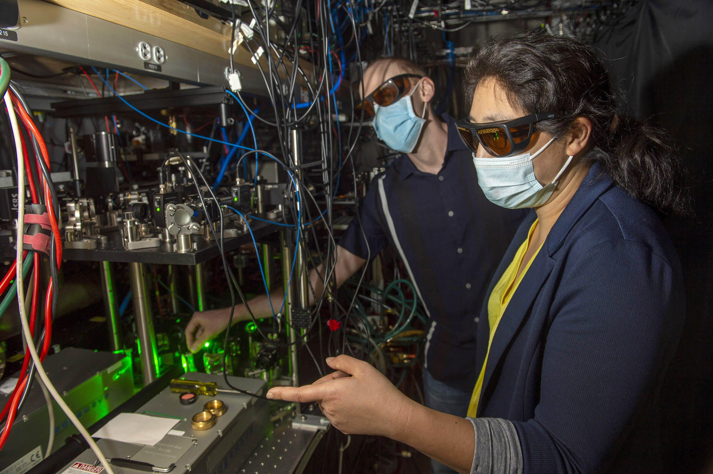 Kang-Kuen Ni, right, and post-doc fellow Matthew A. Nichols do a hands-on consult in their lab.