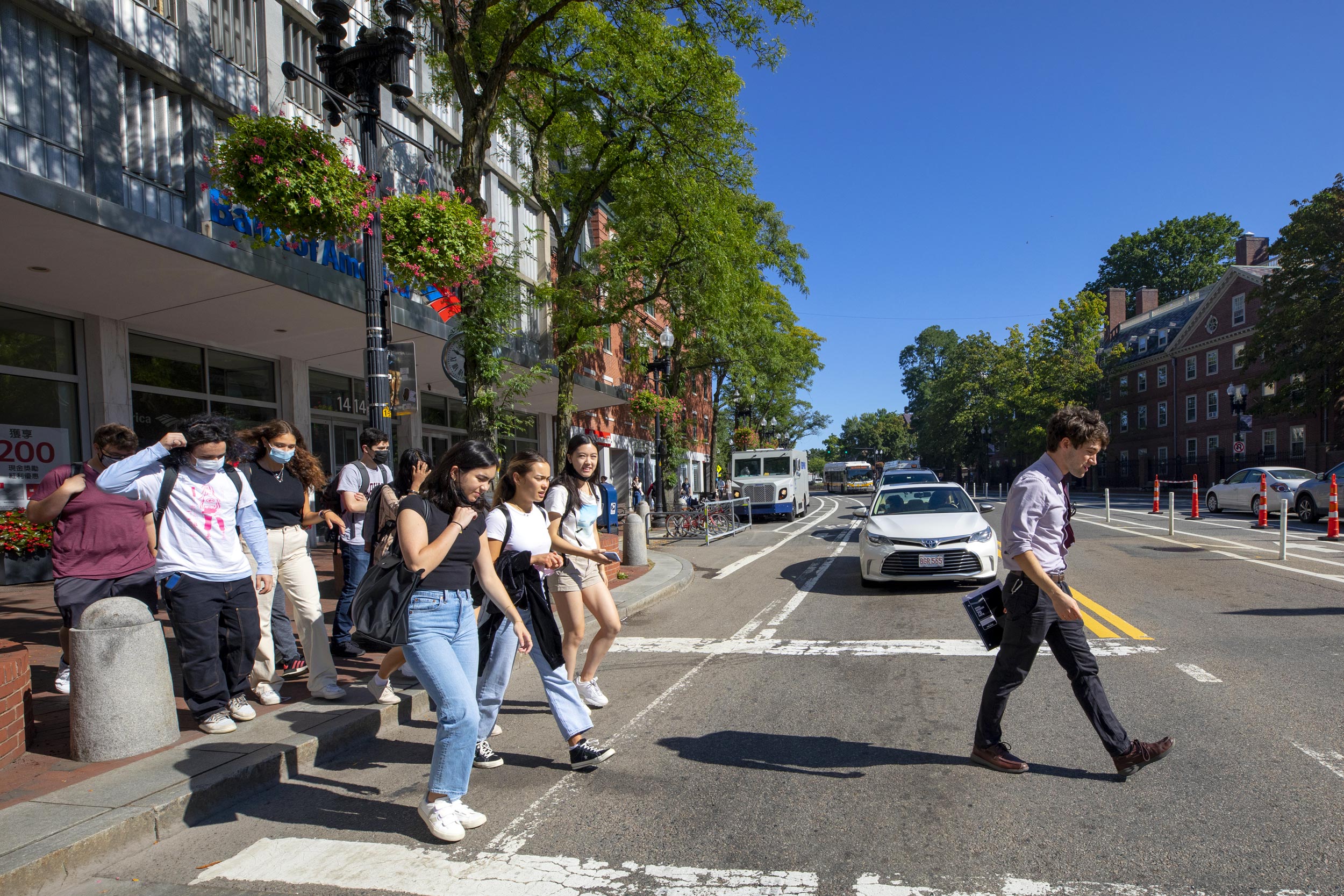 William Whitham walks with his students across Massachusetts Avenue.