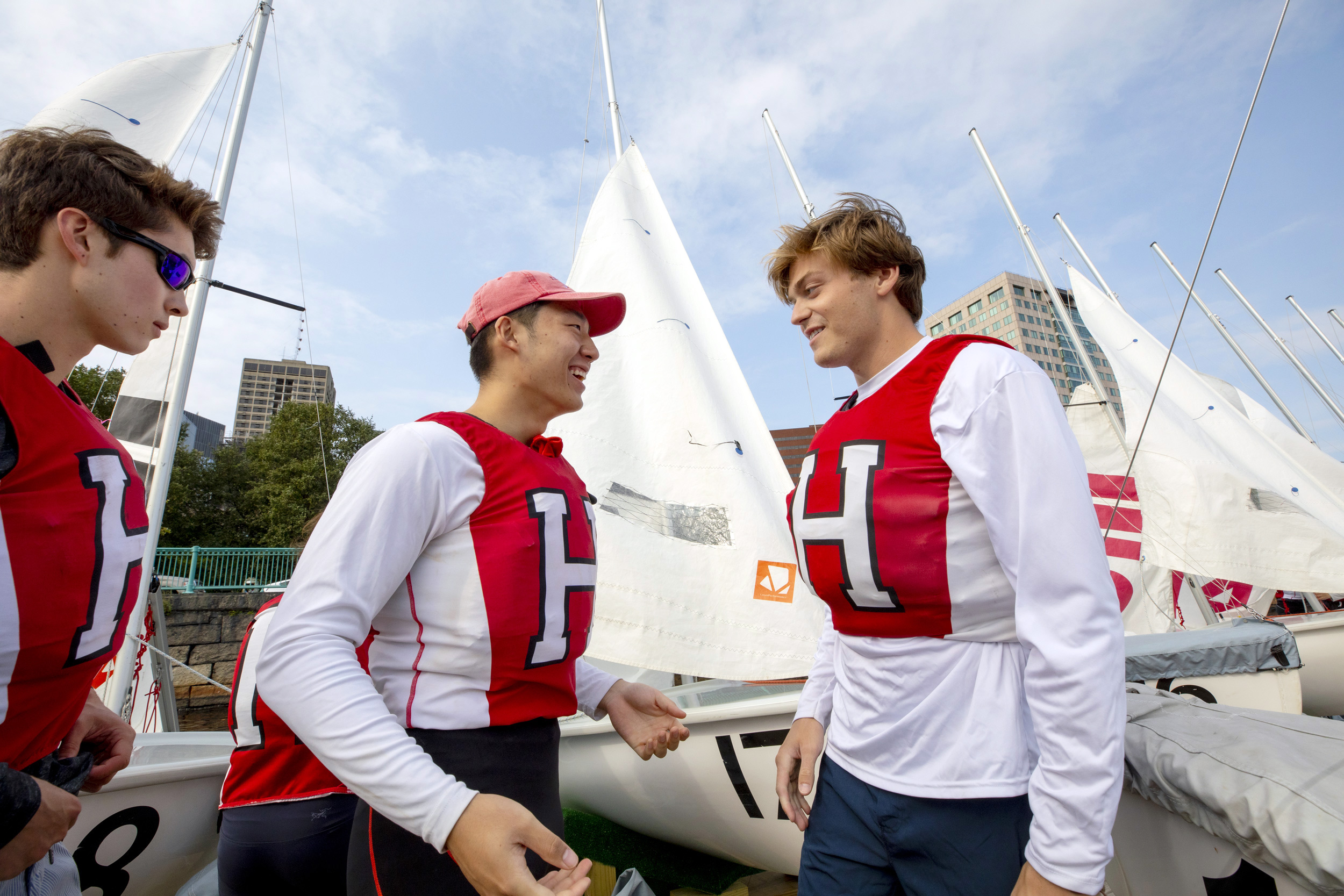 Greeting each other on the dock: Eric Hansen, from left, Alexander Lee, and Gorham Partington, all ’23.