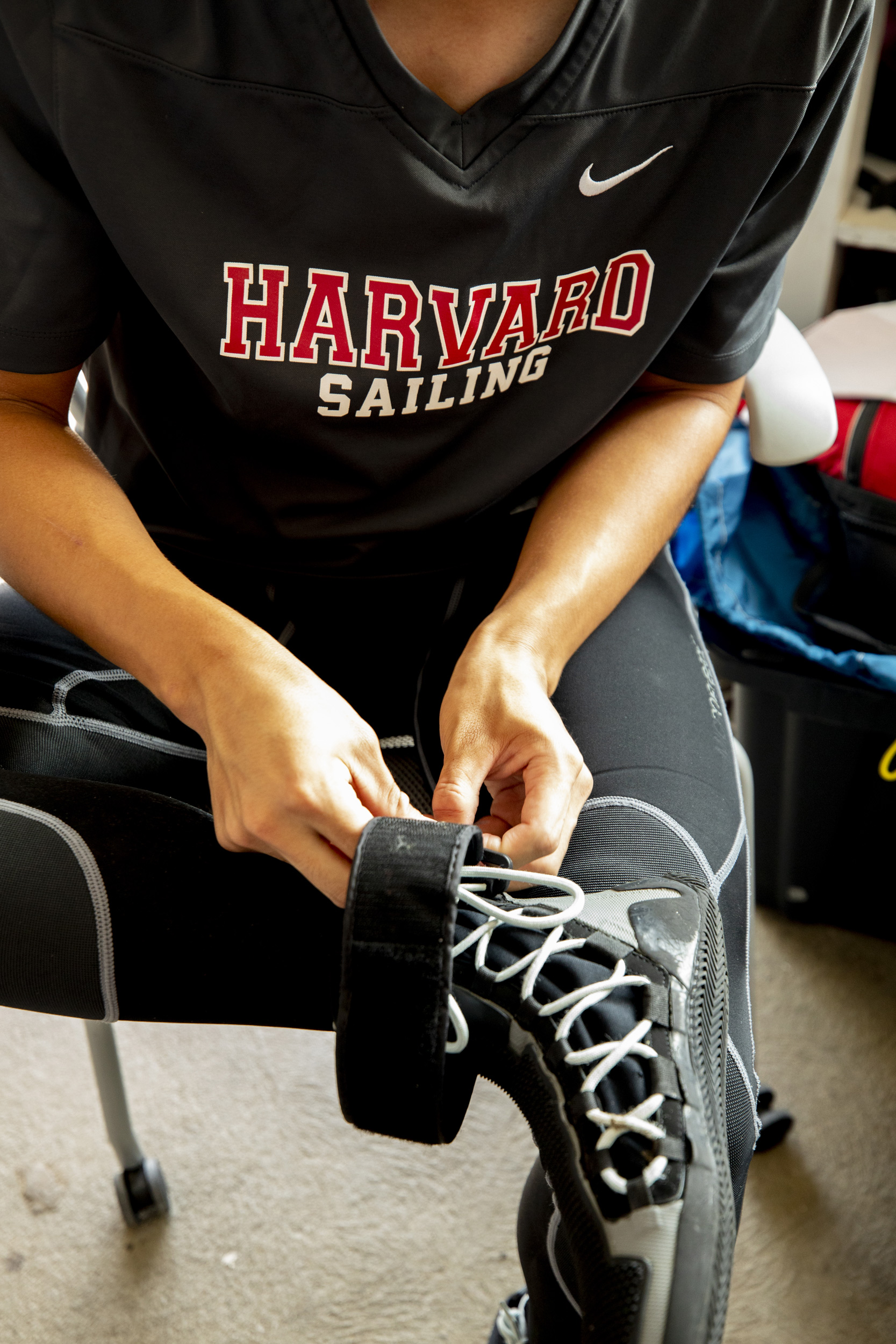 A sailor puts on his boot (possibly minus his sock).