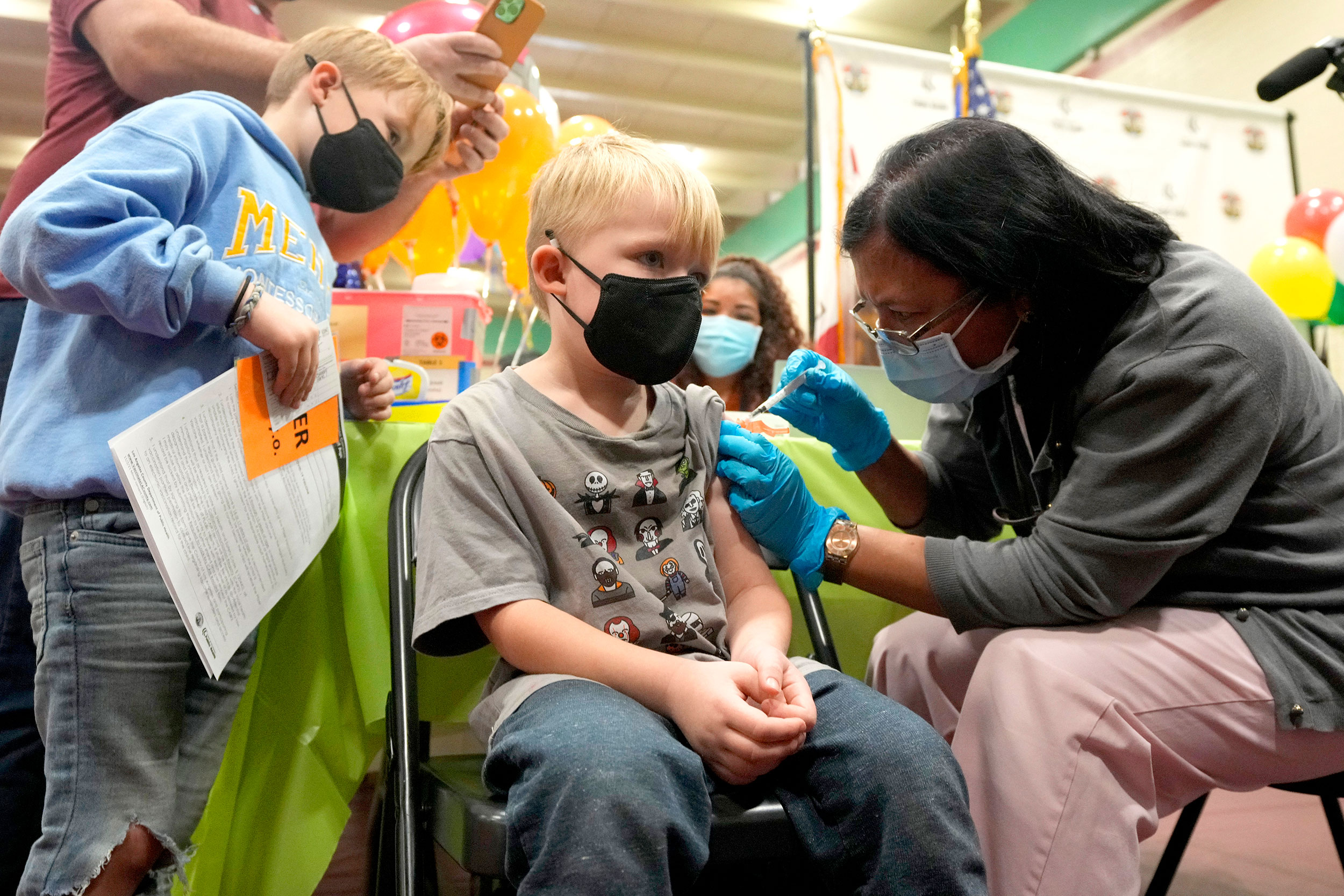 Boys being vaccinated.