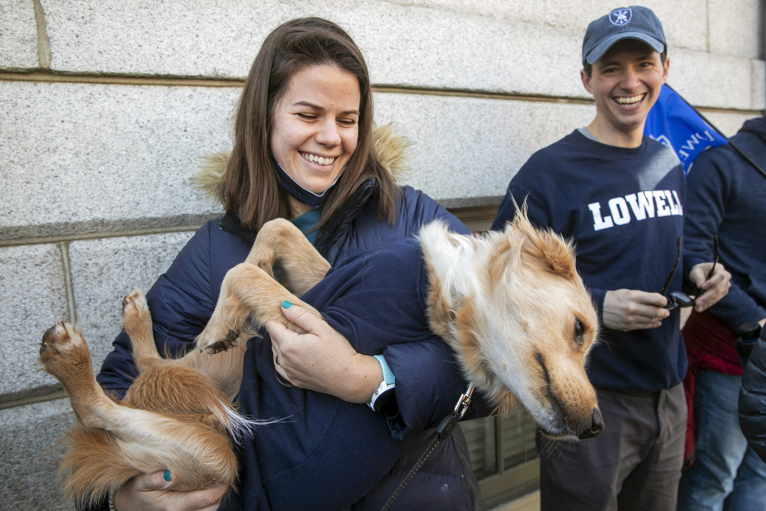 Lowell tutor Meghan Blumstein cradles Scout, one of seven House dogs.