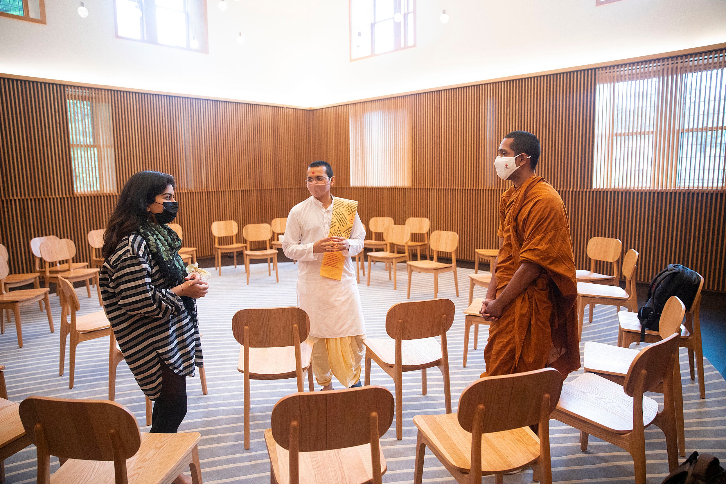 People conversing in Swartz Hall.