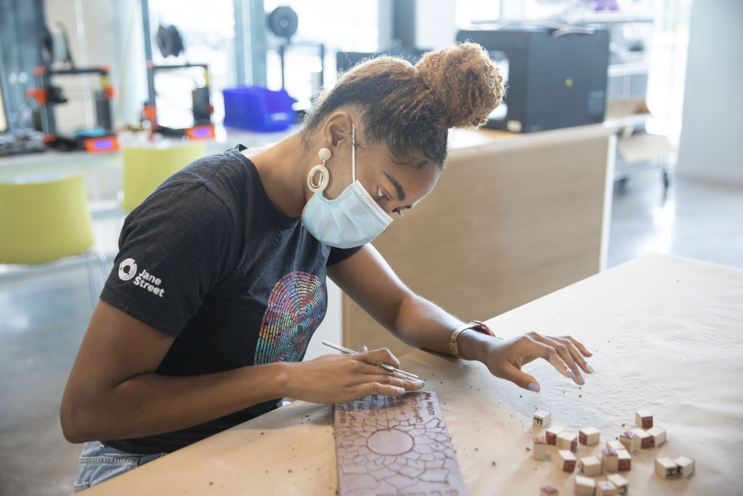 DaLoria Boone etches message into brick.