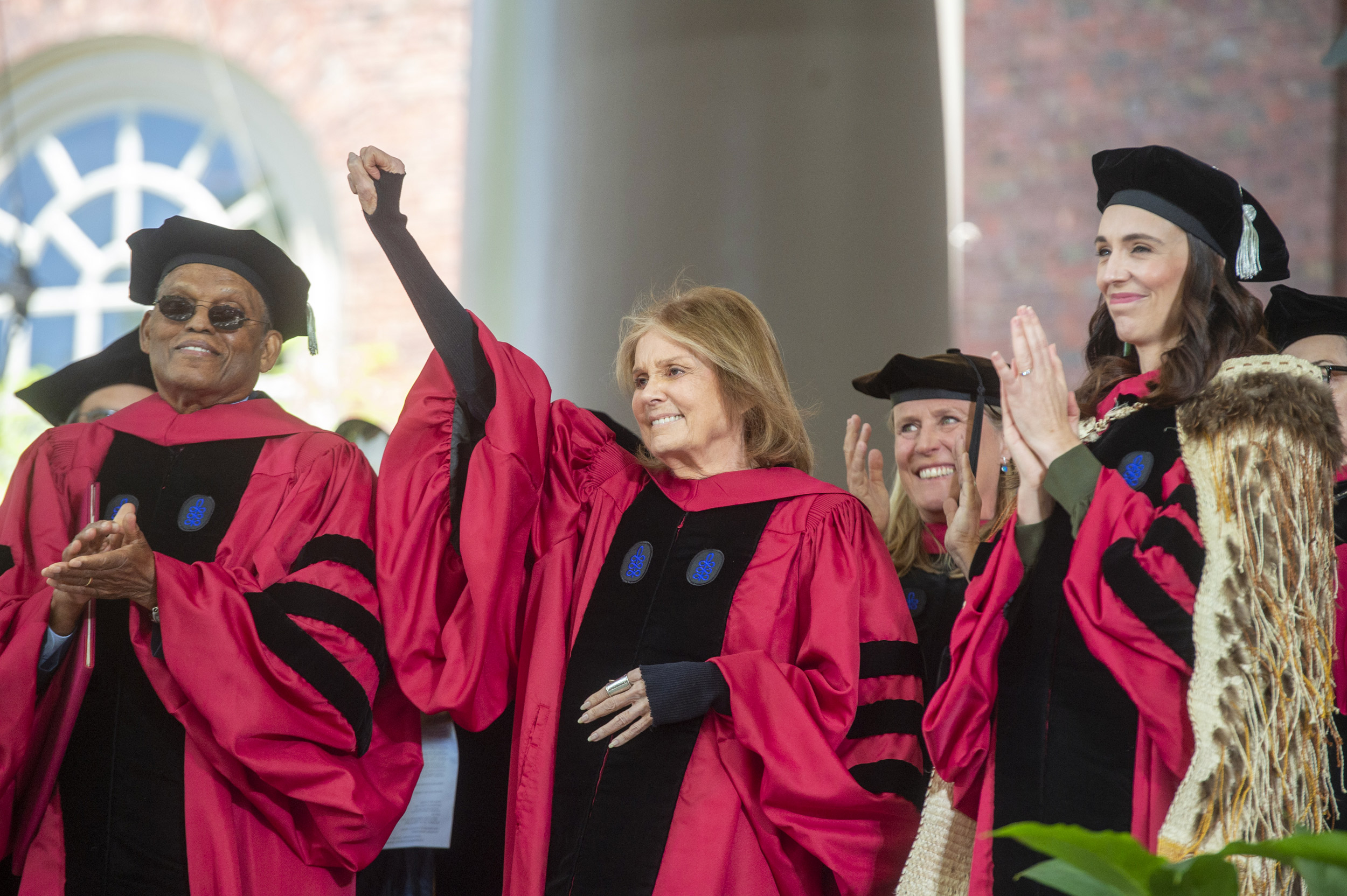 Gloria Steinem raises for fist after being awarded her honorary degree.