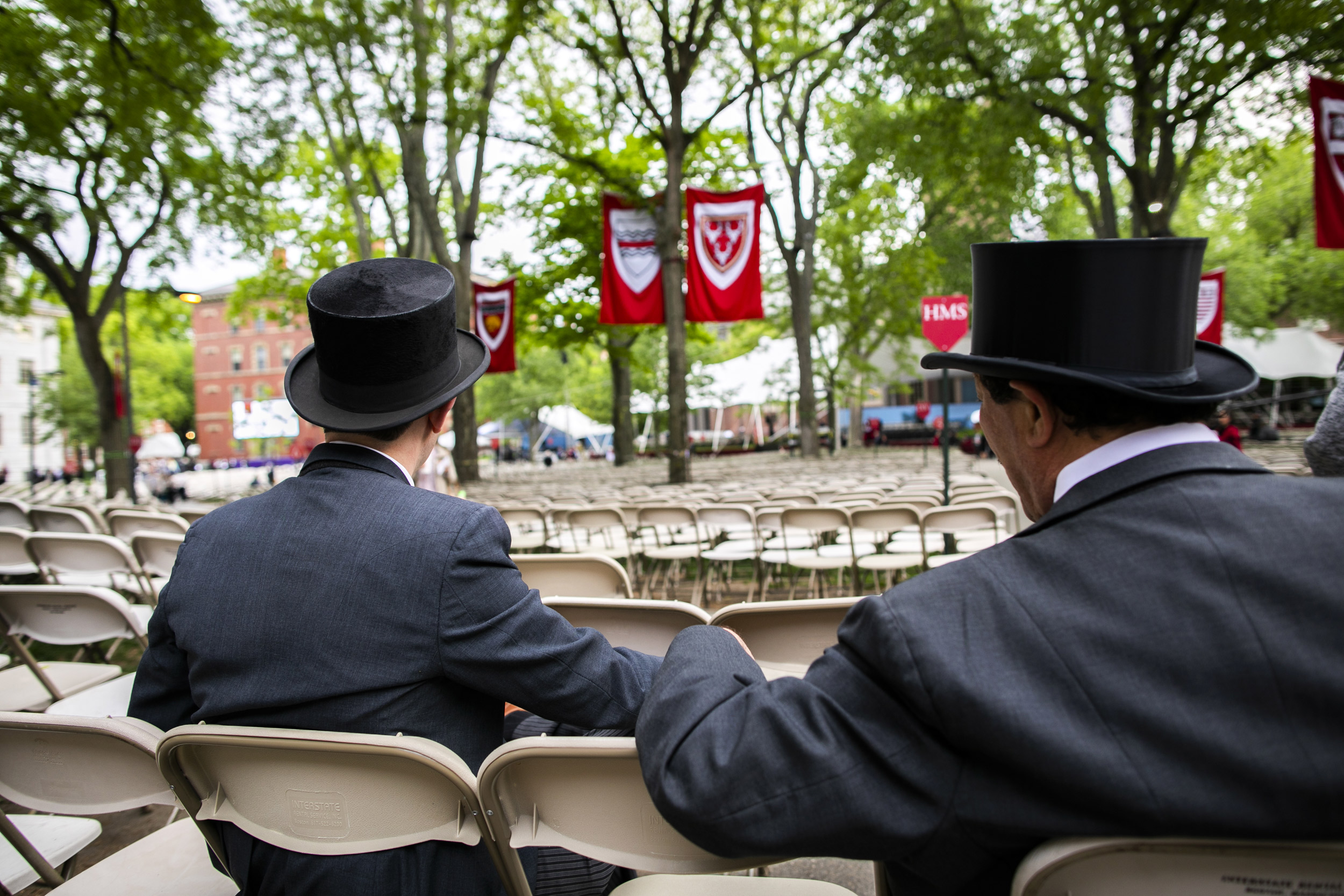 Two marshals Matthew Alderete AB ’19 (left) and Michael Alderete AB ’79 await the crowds in the Yard before the gates open.