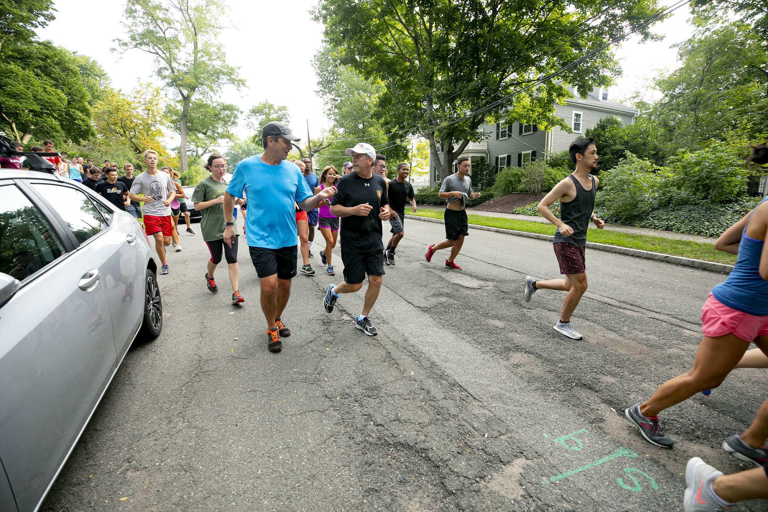 Larry Bacow runs with students.