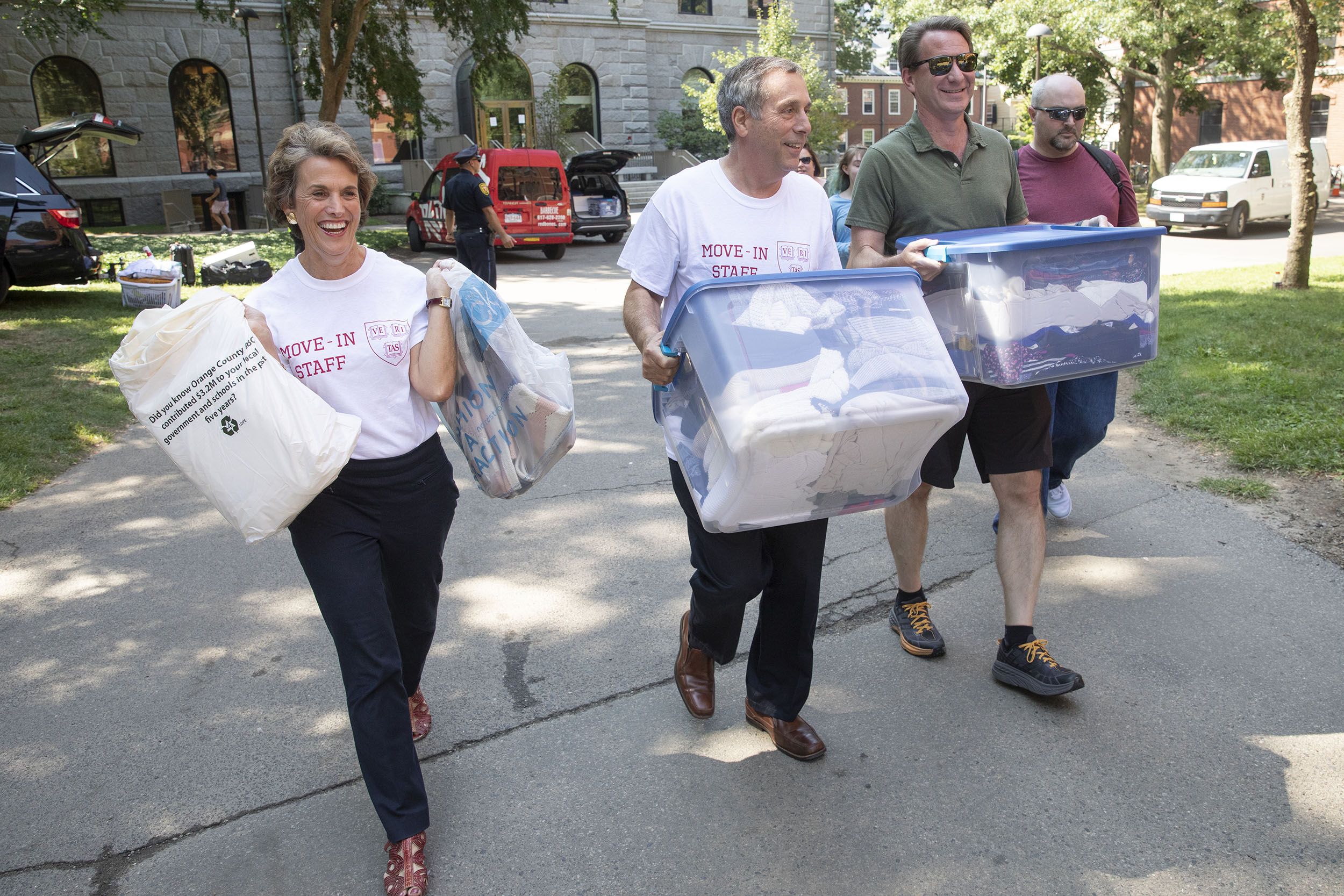 Adele and Larry Bacow help students move in to the dorms.