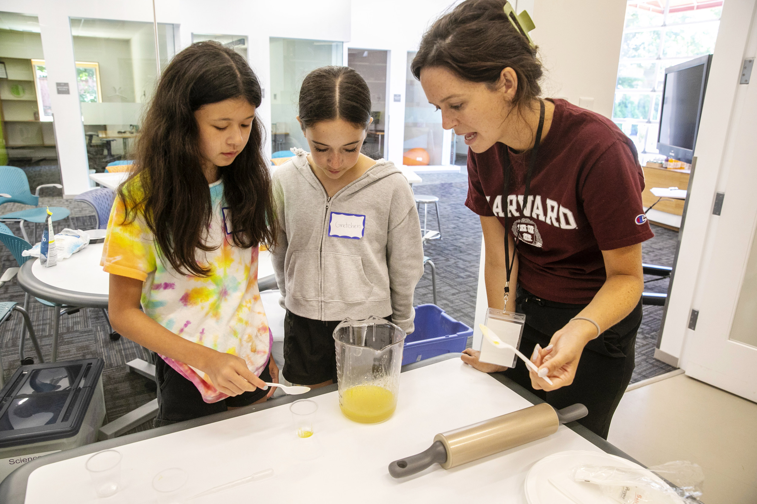 Vivian Hale (from left) and Gretchen Ensdorf listen to instructor Nora Birner as she talks about the ingredients in the cylinder.