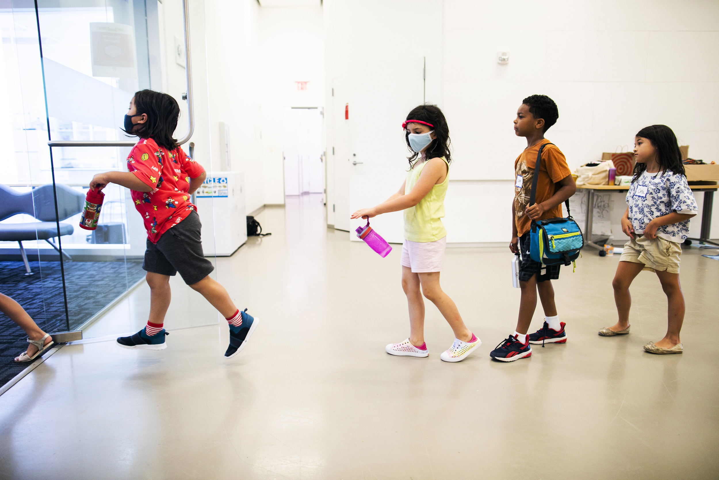 Ronin Rodriguez (from left), Maeve Connal, Oak Northcross Aquino, and Orla Strubel line up at snack time.