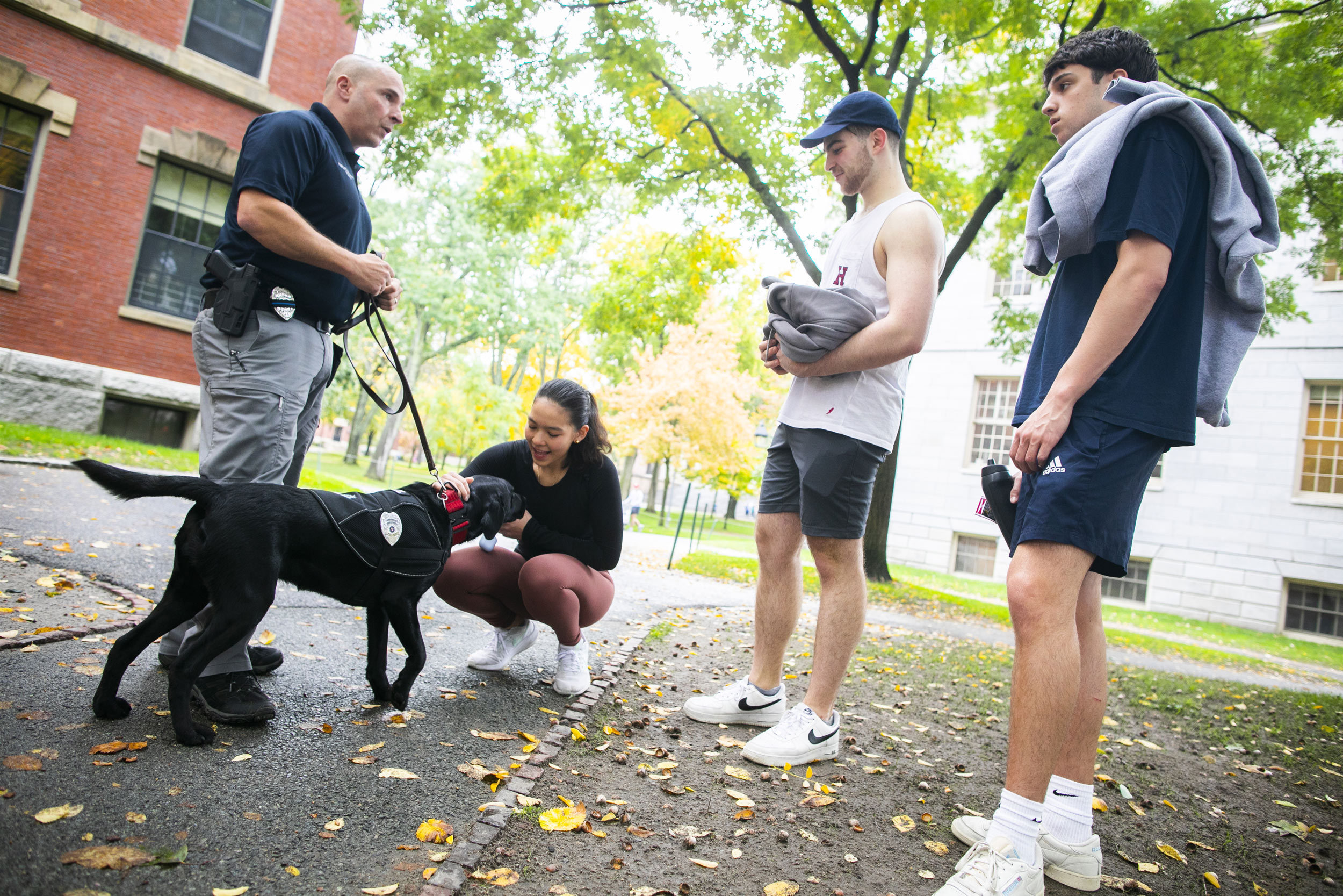 Students pet Sasha as Fumicello walks her through the Yard.