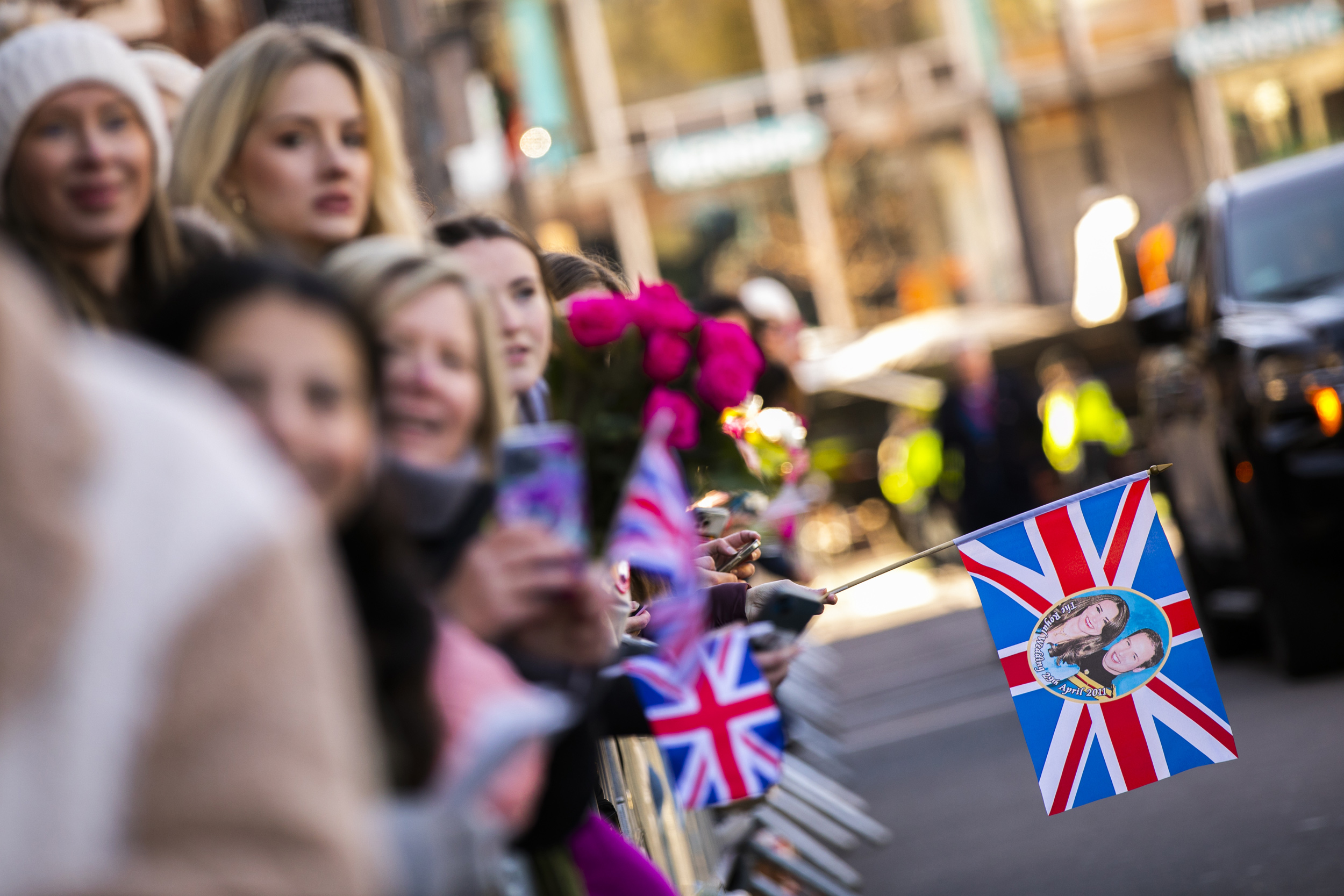 Princess of Wales fans hold British flags.