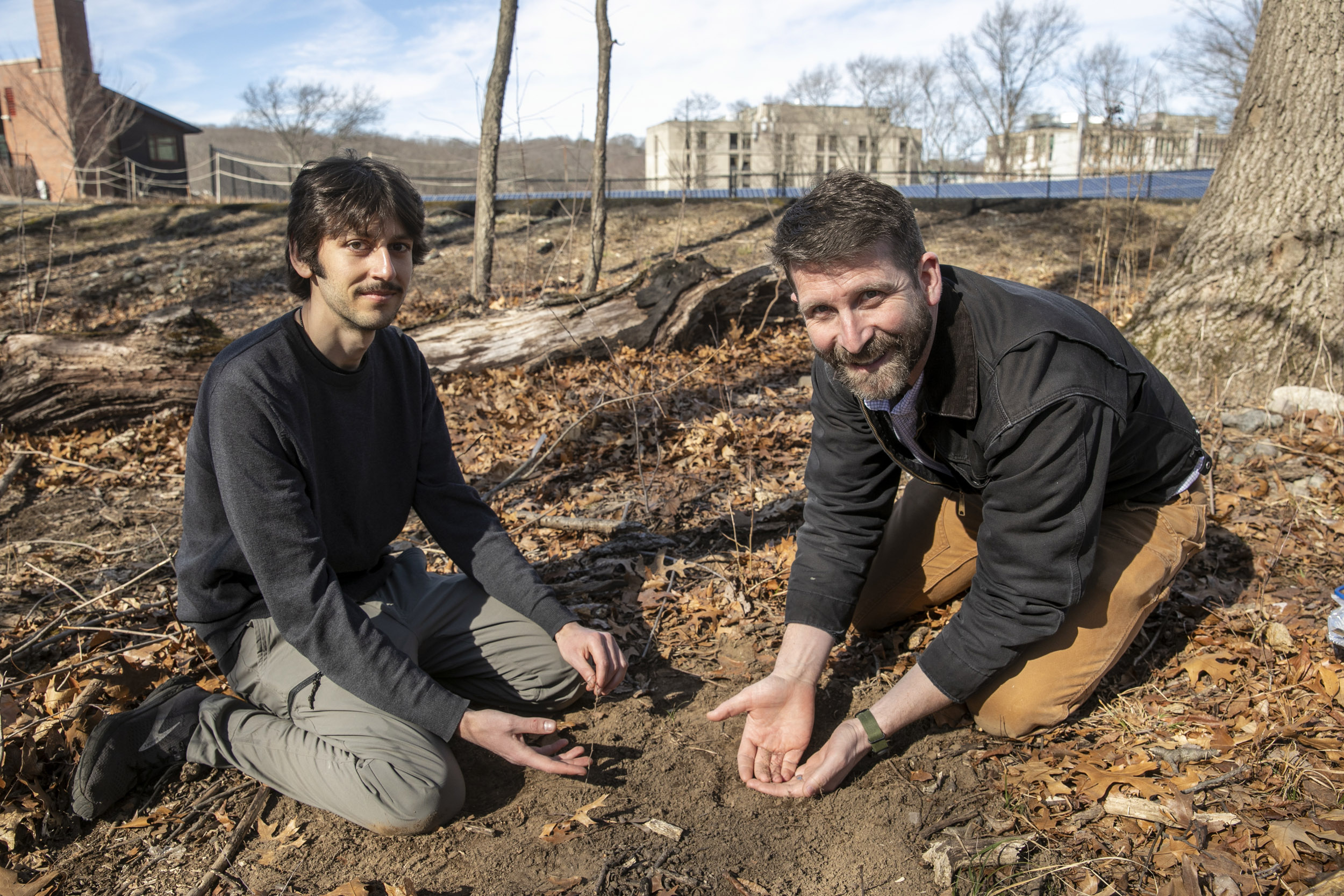 Nikhil Chari and Benton Taylor collect root exudates.