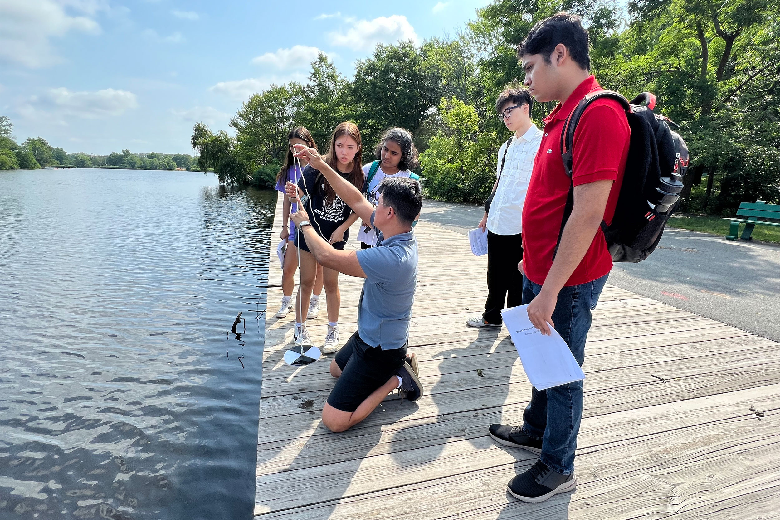 Checking water along the Charles River.