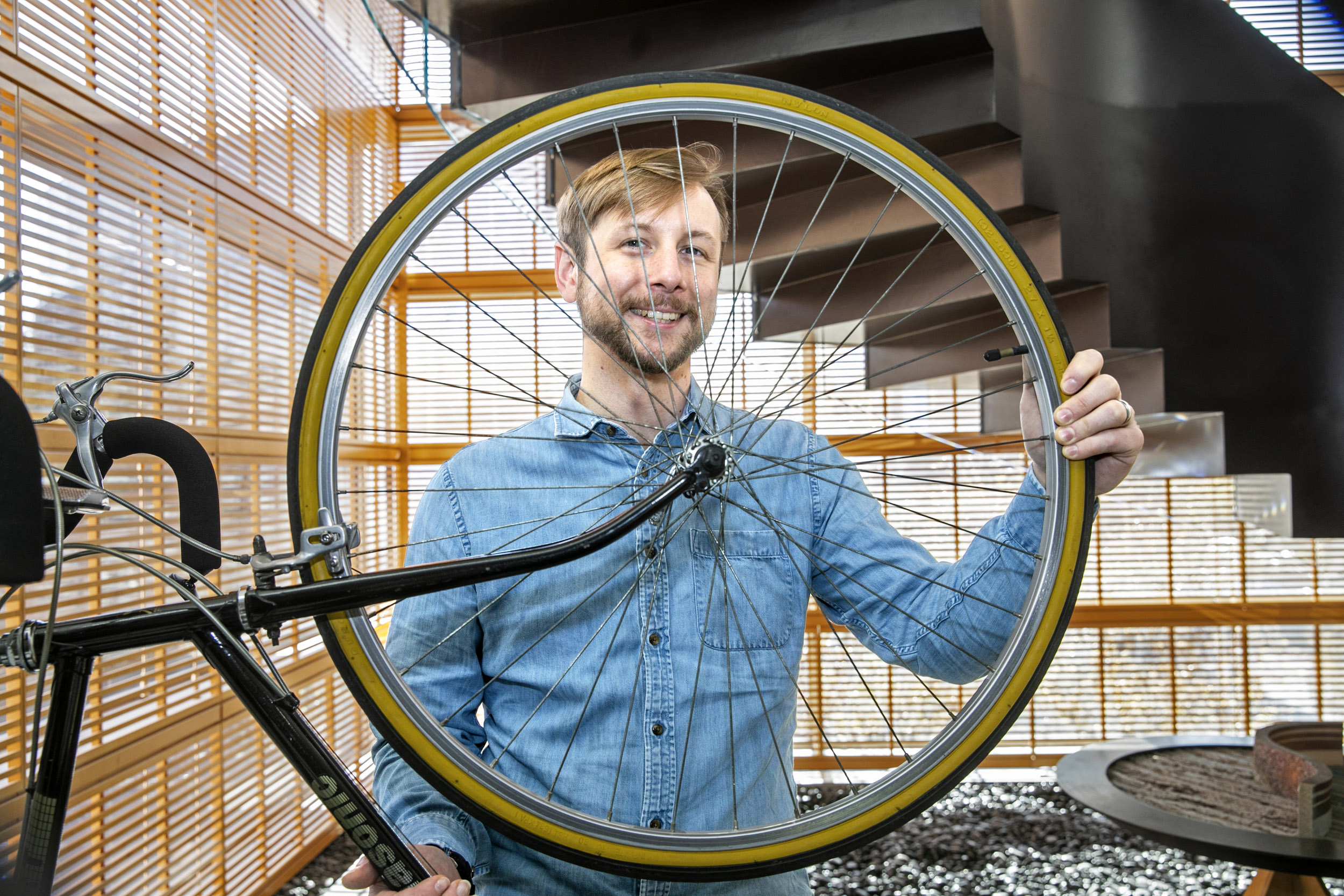 Cory Gillis holds a bike.