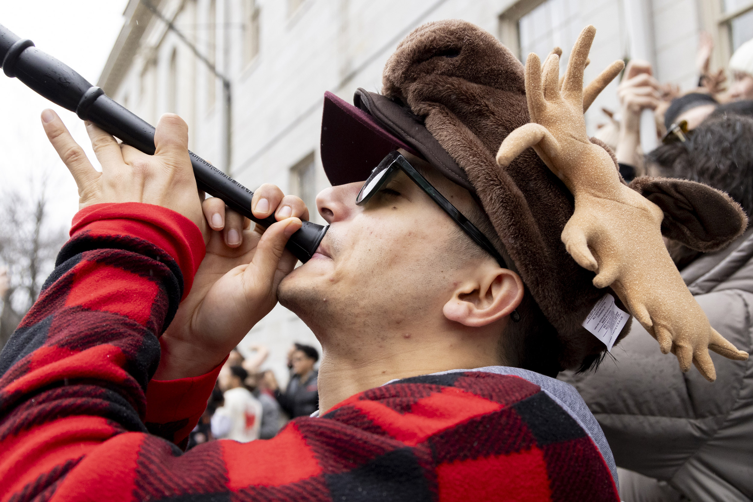 A student cheers for Dunster House in Harvard Yard on Housing Day.