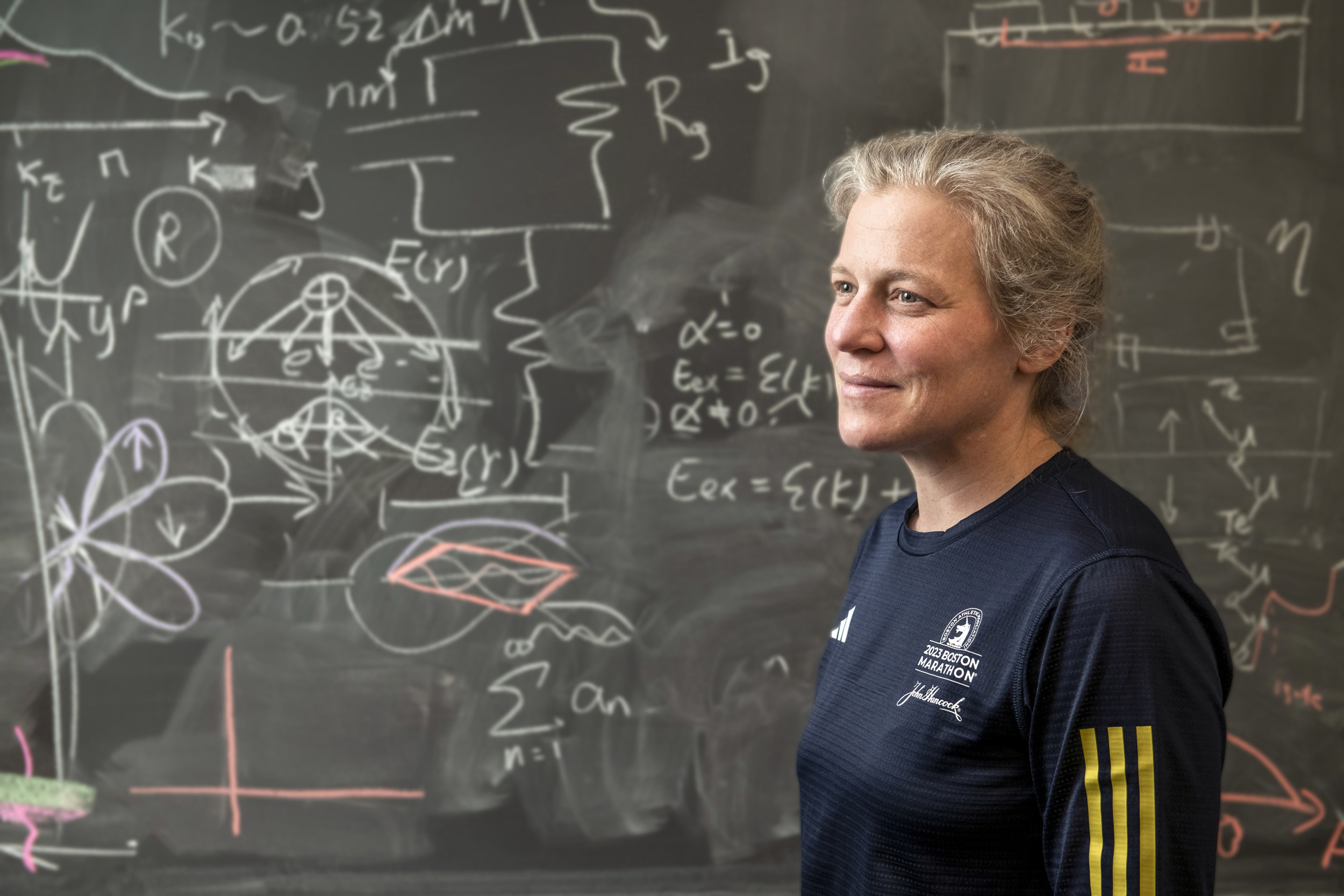 Jenny Hoffman is pictured alongside a chalkboard.