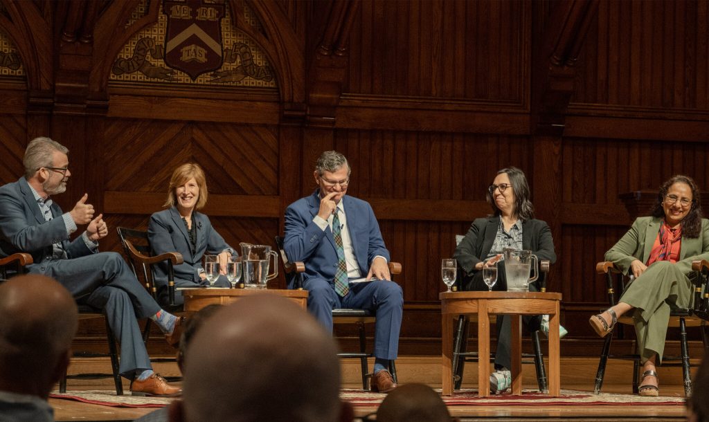 A group of panelists on stage