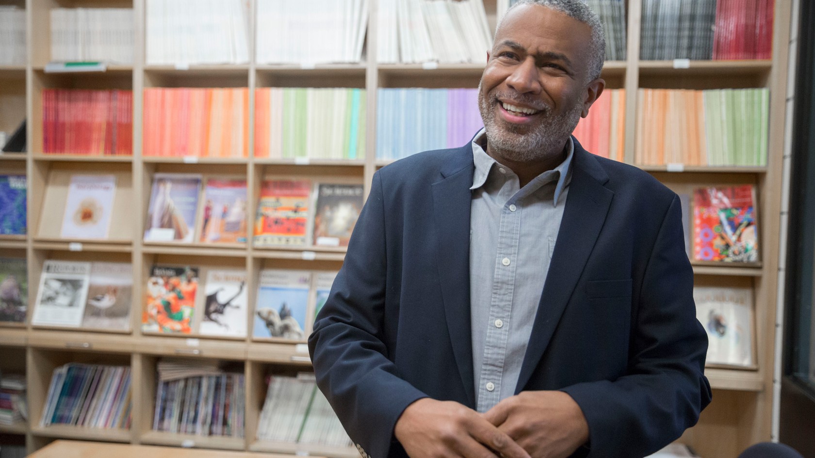 Scott Edwards standing against a bookcase.