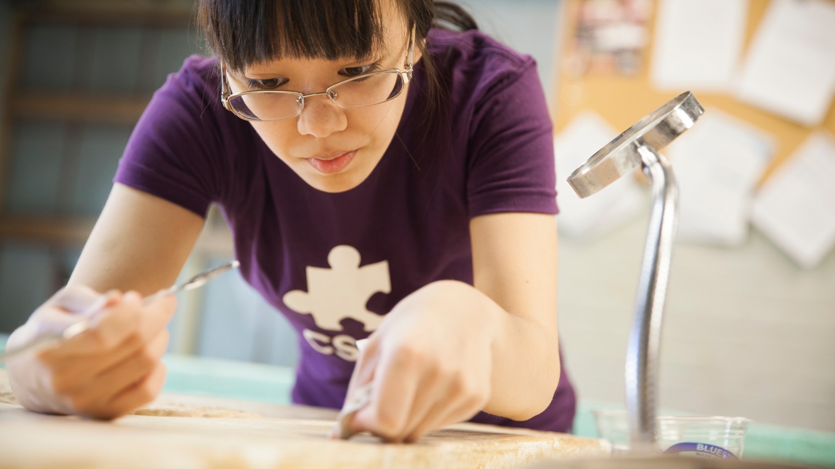 A woman working at a work bench