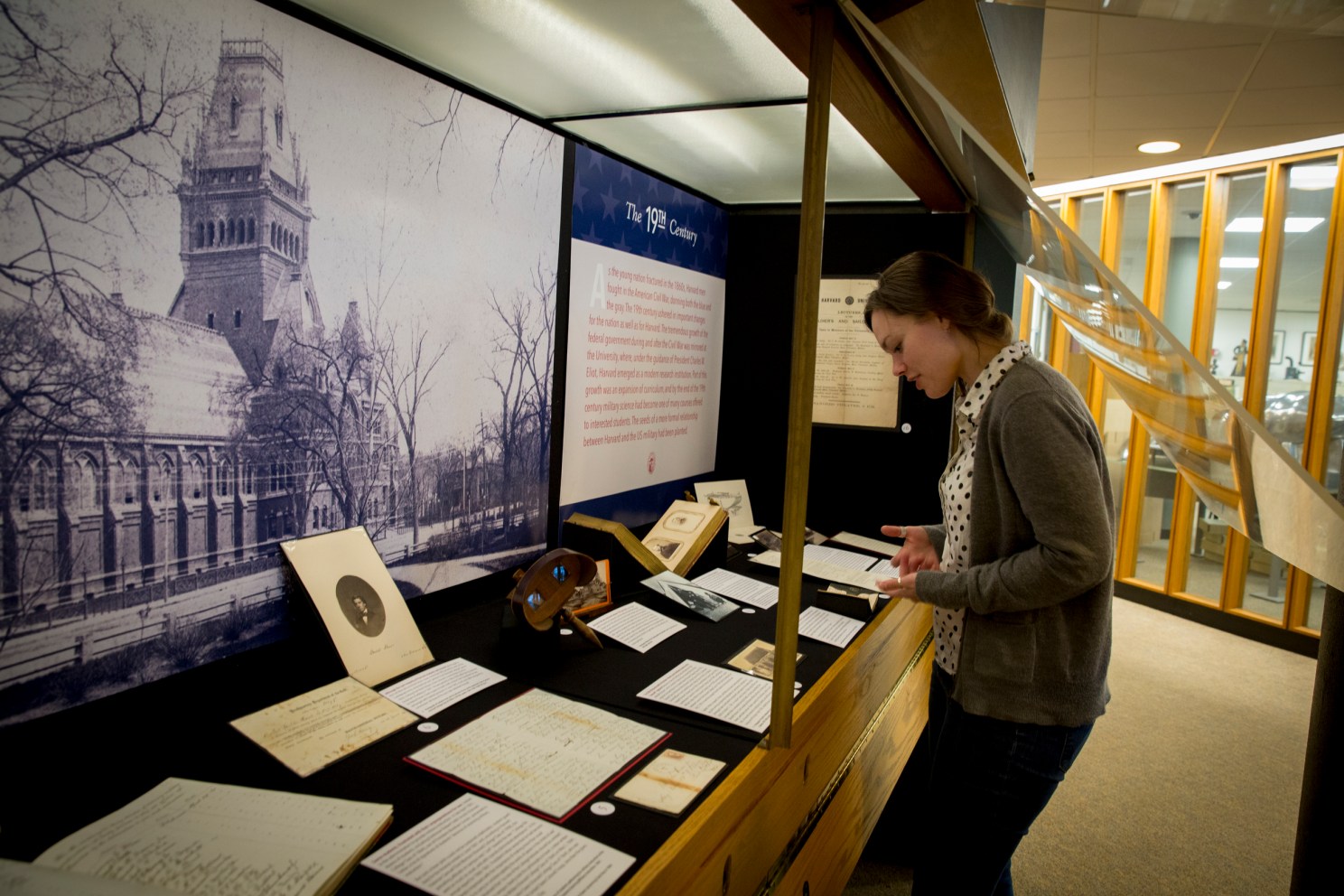 A woman looks at an exhibit at a library