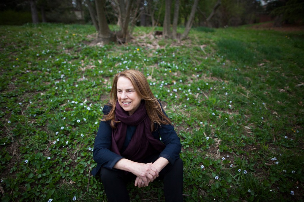 Pamela Silver sitting in a field.