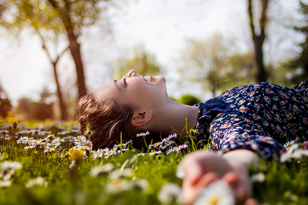 girl in field laughing