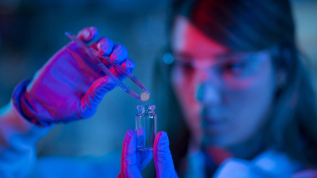 researcher holds a device