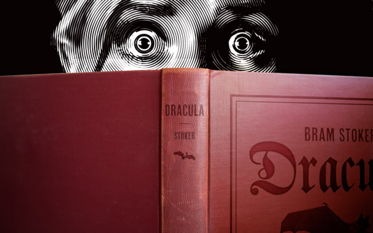 Illustration of frightened reader peering over "Dracula."