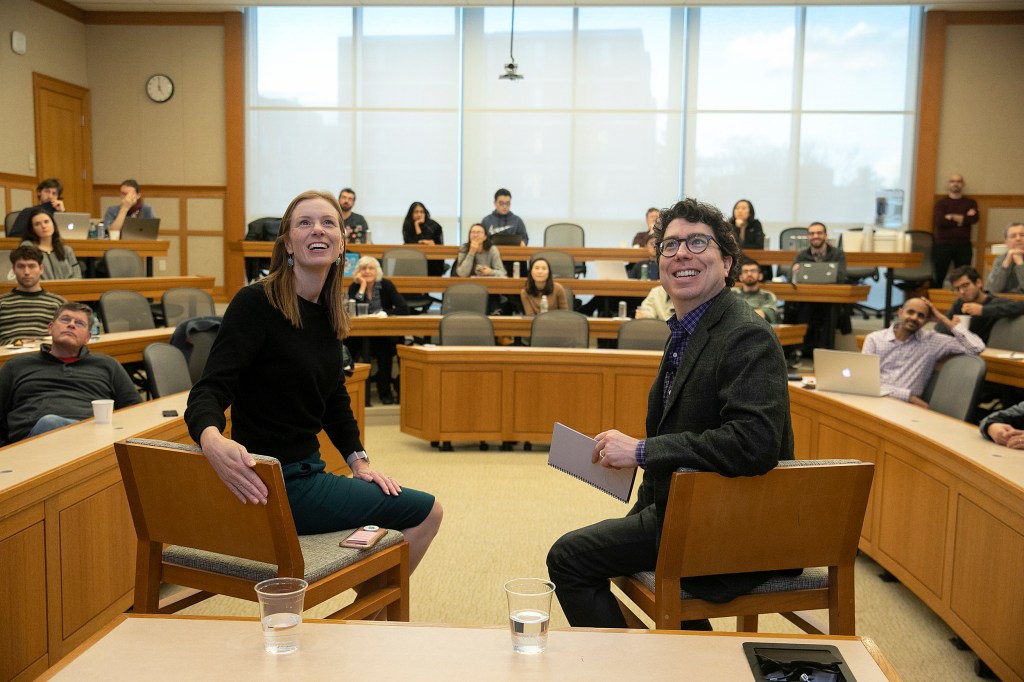 Monika Bickert and Jonathan Zittrain looking up at a screen