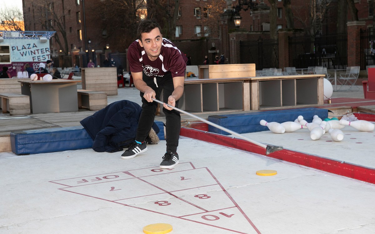 a student playing shuffleboard