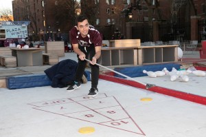 a student playing shuffleboard
