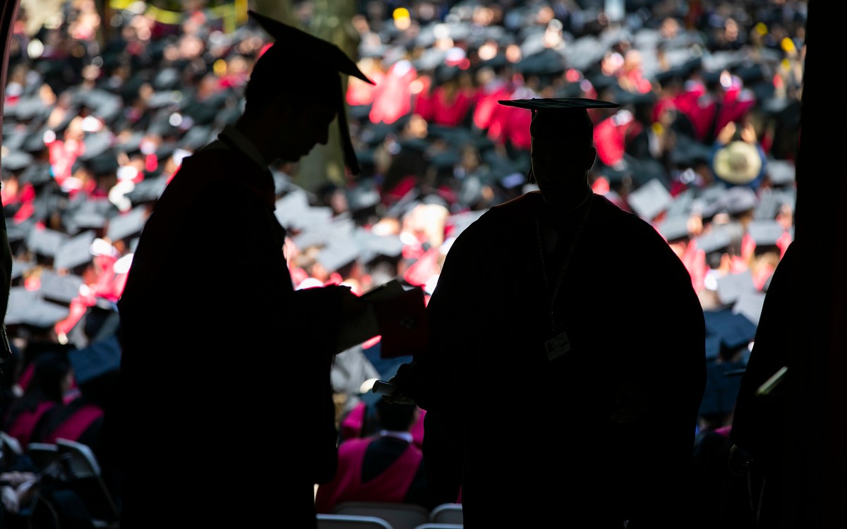 Graduates in silhouette.