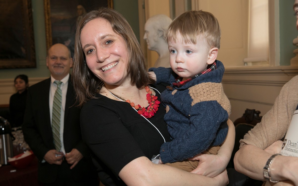 A woman holds her toddler.