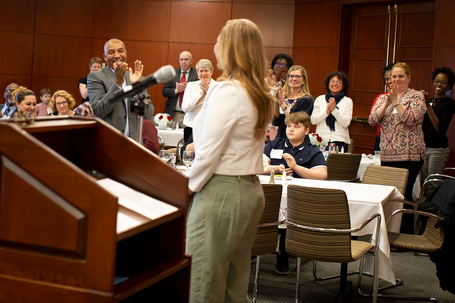 Luz Orozco receives a standing ovation after speaking at the Bridge Program annual dinner.
