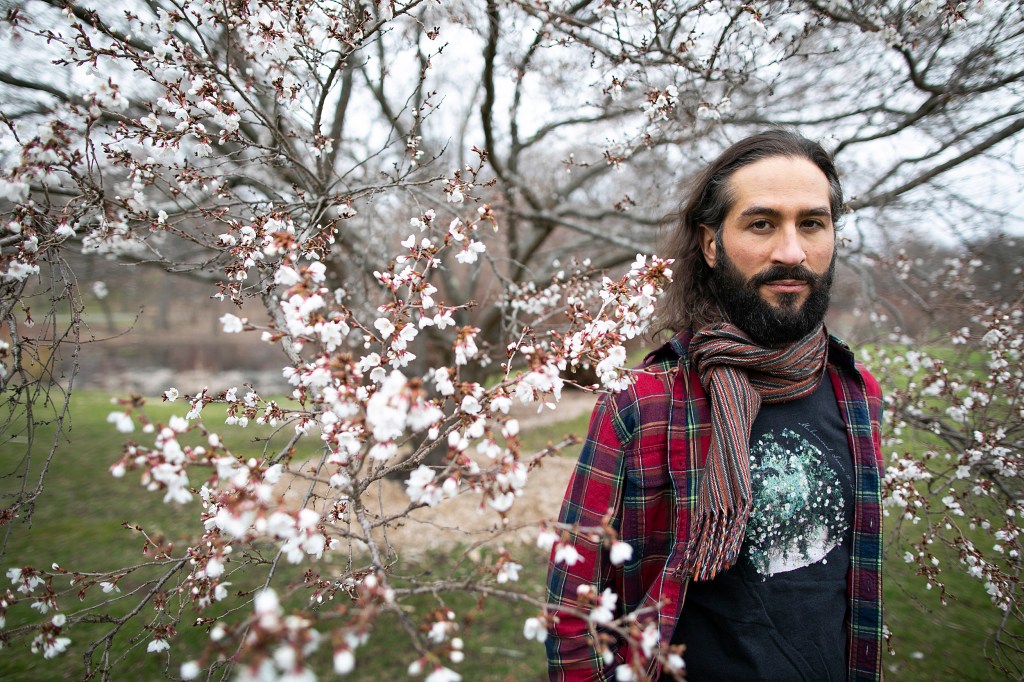 Samimi standing near a tree