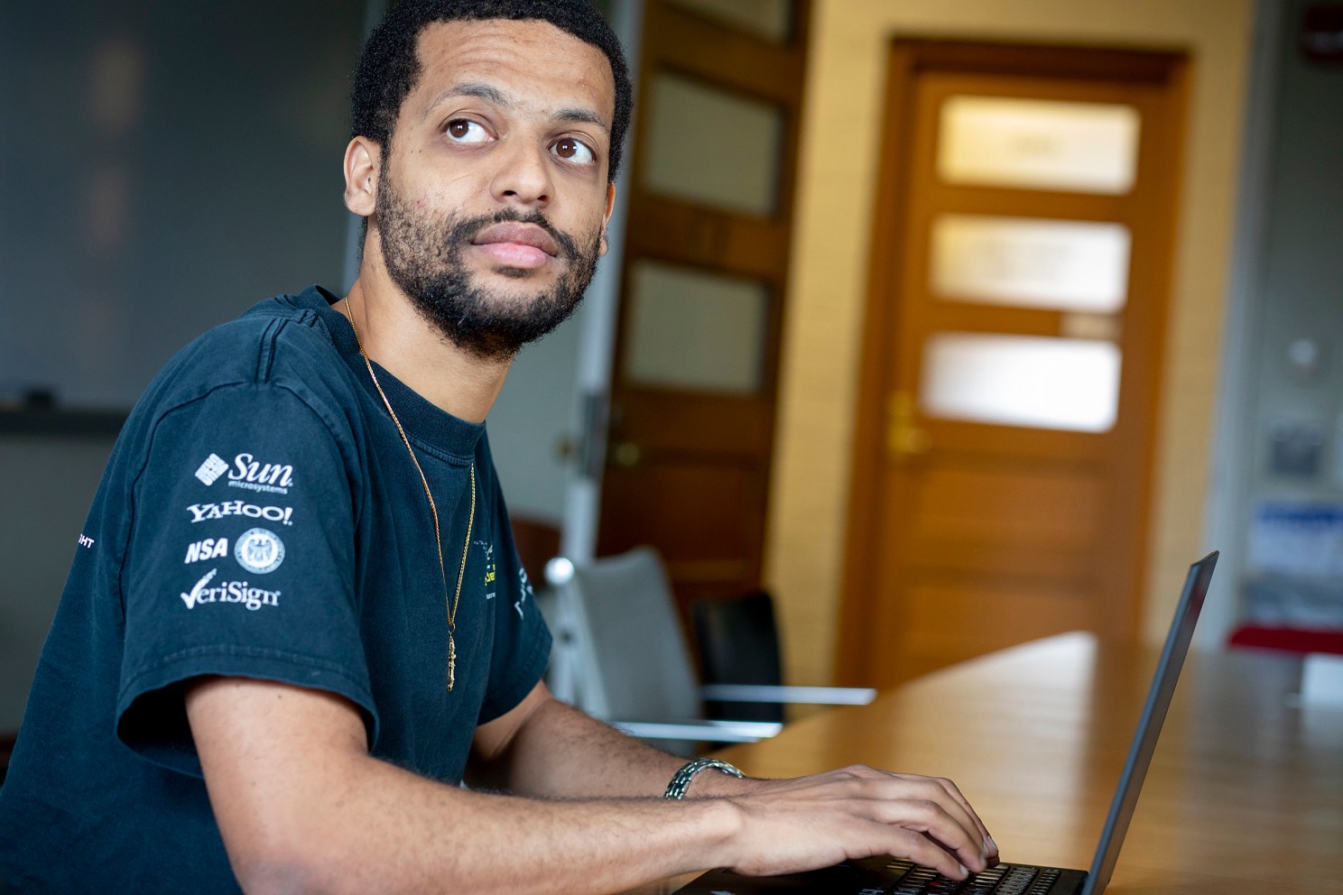 Jelani Nelson sitting in front of a laptop